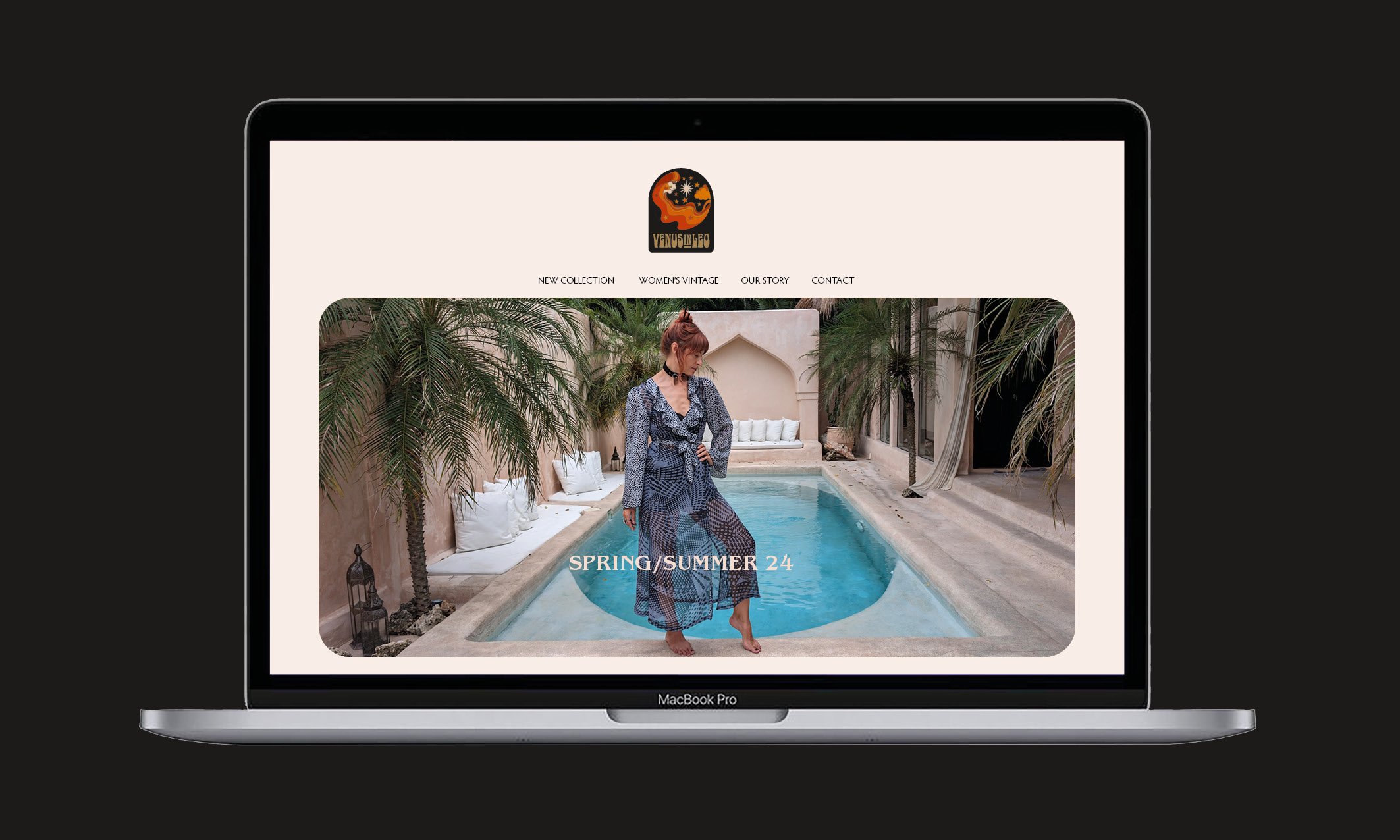 Laptop screen displaying a fashion website with a woman in a blue dress by a small pool, surrounded by palm trees and white pillows, promoting a spring/summer collection.