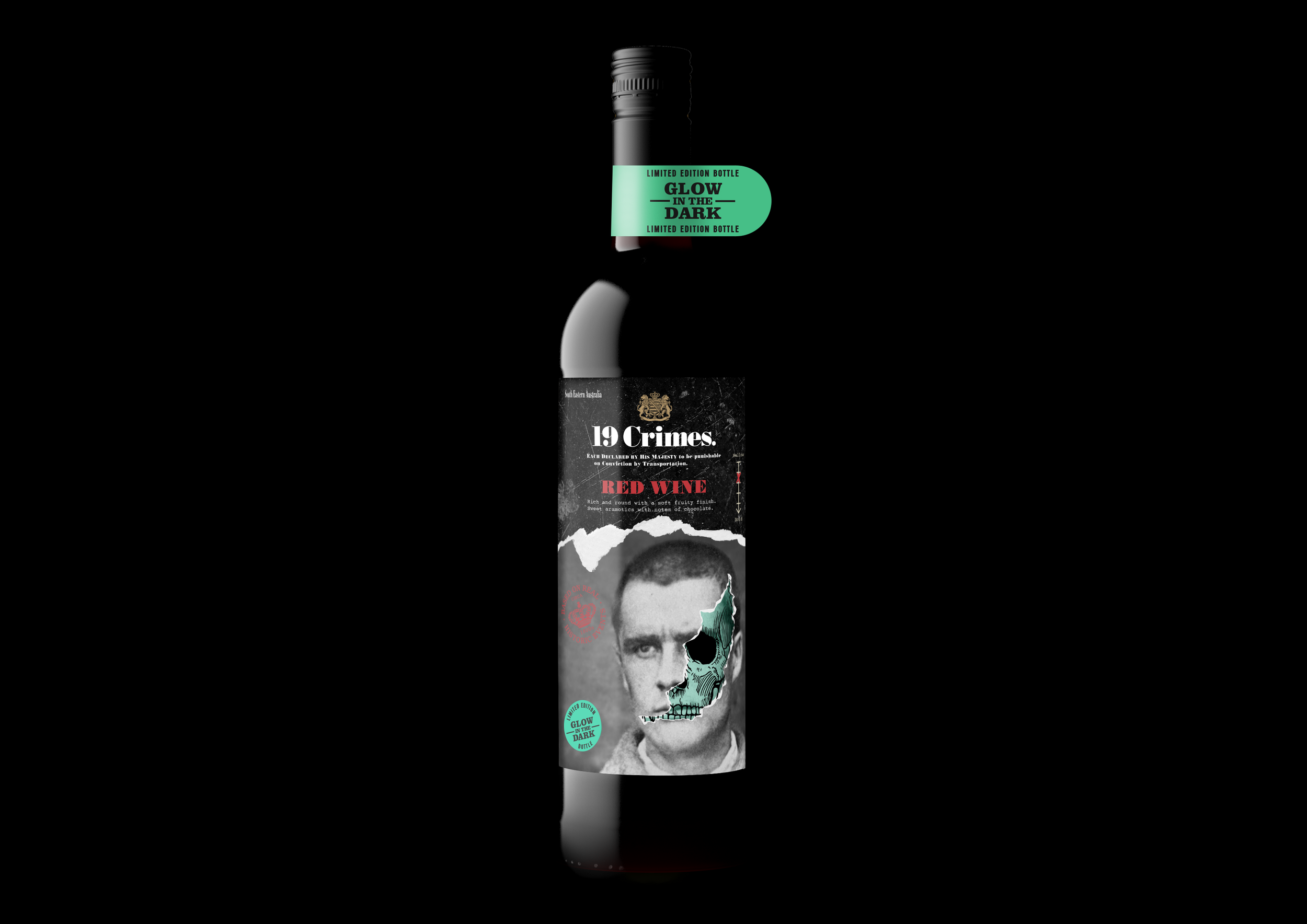 A black bottle with a label that features a man's face partially covered with a skull illustration. The label includes the text '199 Crimes,' 'Red Wine,' and other design elements, with a teal sticker at the top that says 'Glow in the Dark.'