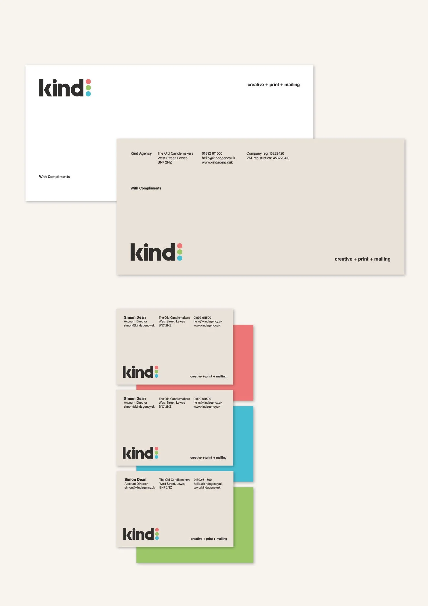 Set of branded business stationery including letterheads and business cards for a creative agency named "kind", featuring colorful dots and contact information.