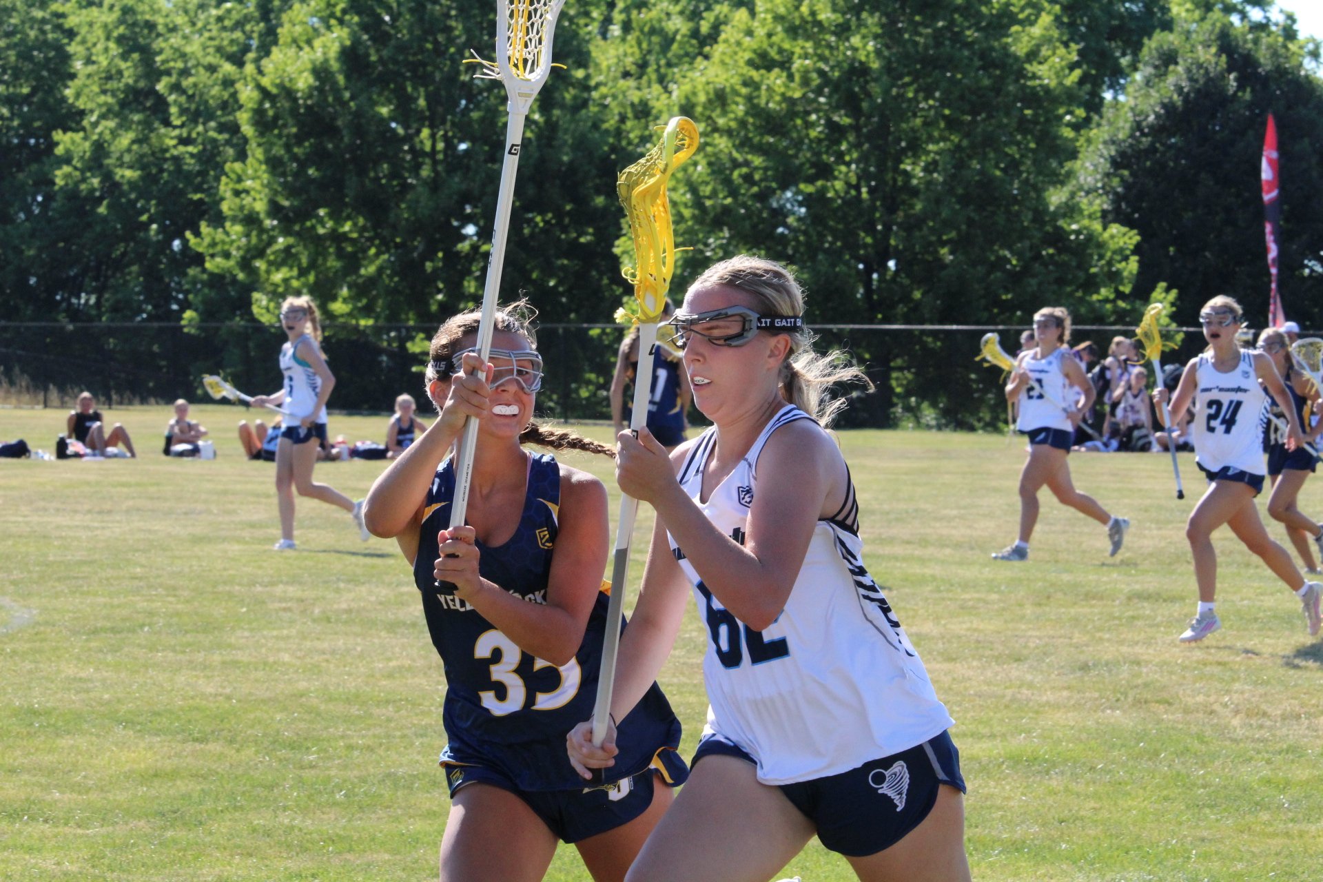 Young women playing lacrosse on a field, with a goal net in the background, Nor'easter Lacrosse, Connecticut's premier lacrosse travel program
