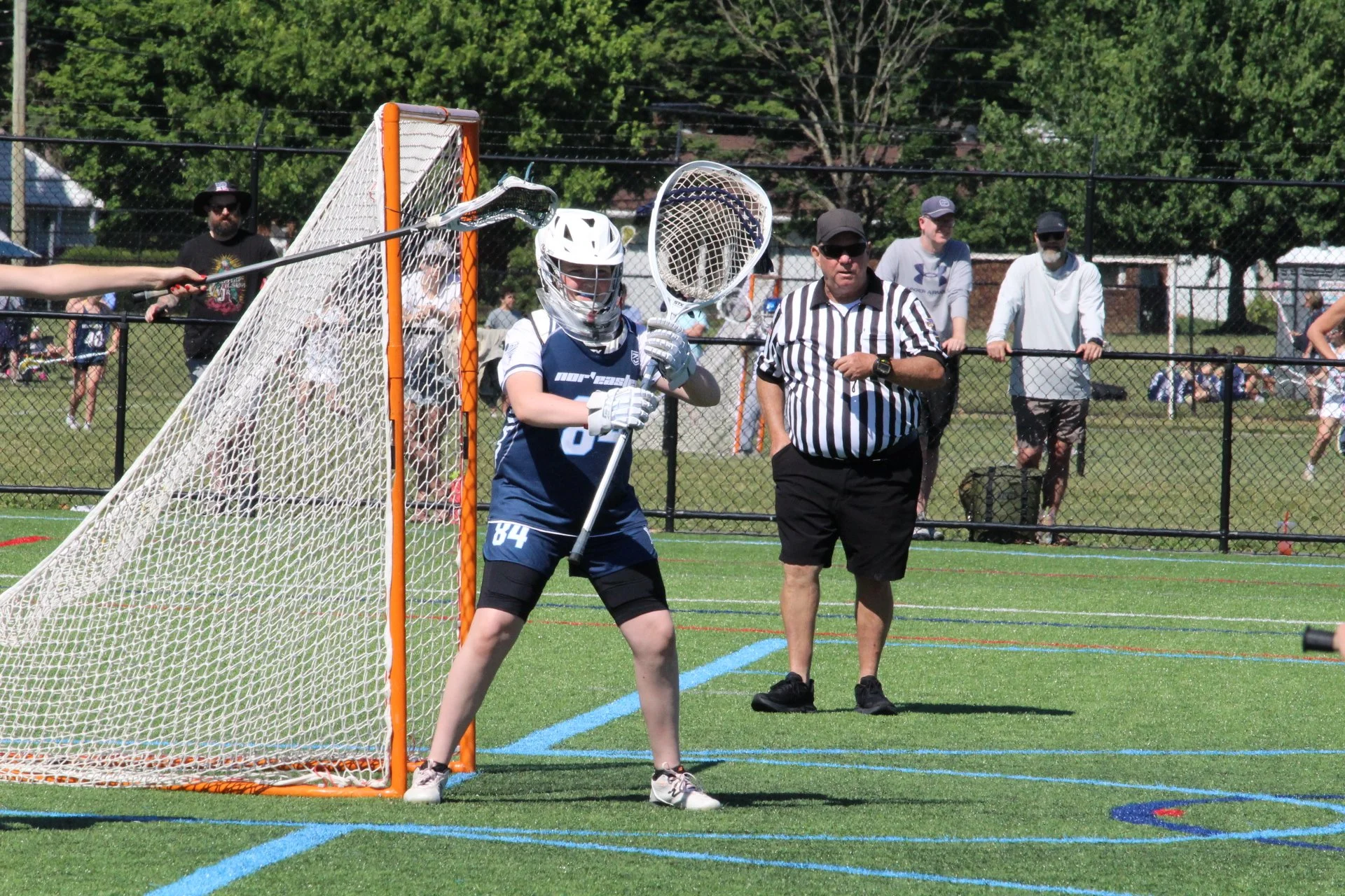 Young women playing lacrosse on a field, with a goal net in the background, Nor'easter Lacrosse, Connecticut's premier lacrosse travel program