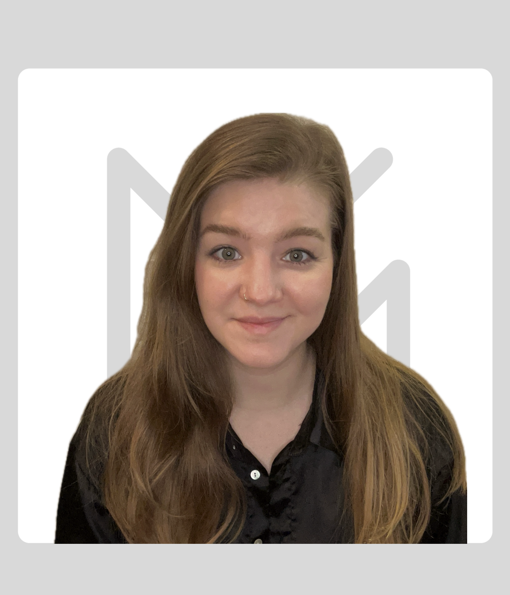 A woman with long hair smiling, wearing a black shirt, standing against a white background with a gray Kawartha Lakes Museum & Archives Logo.