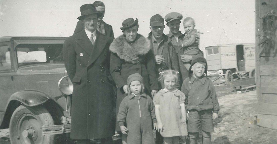  Hutton and Archer family standing in front of an T. J. Archer Dairy cart. The archer farm was located on Highway 36  where the present Lindsay landfill is today. 