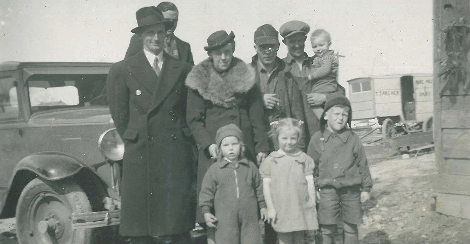 Hutton and Archer family standing in front of an T. J. Archer Dairy cart. The archer farm was located on Highway 36 where the present Lindsay landfill is today.