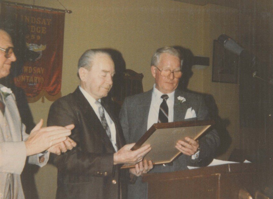  Peter Hutton receiving the Citizen of The Year plaque from Charlie Stoddart.  1983. 