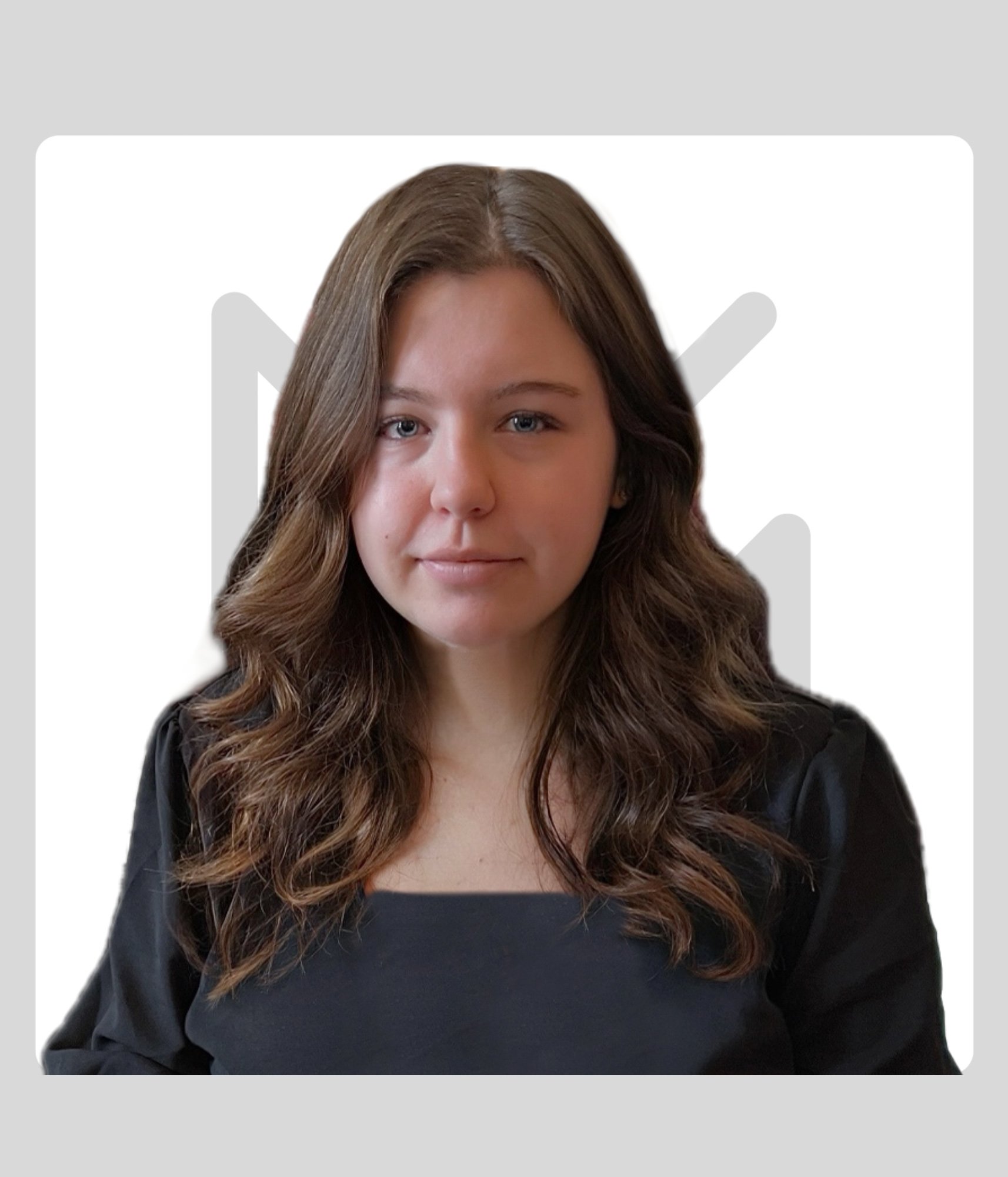 Portrait of a young woman with wavy brown hair wearing a black top, on a white background with a grey Kawartha Lakes Museum & Archives Logo.