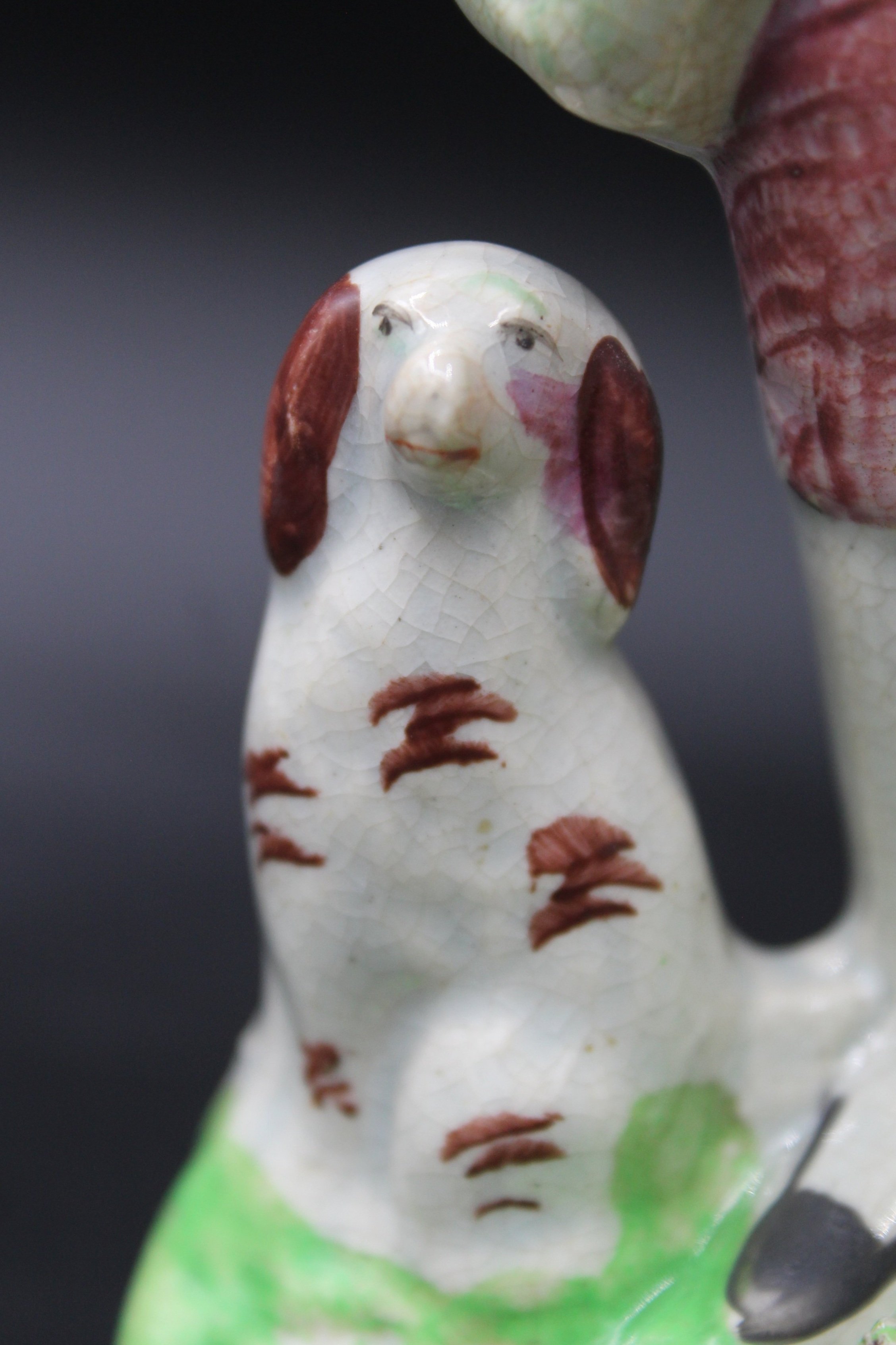 Ceramic dog figurine with brown ears and speckles