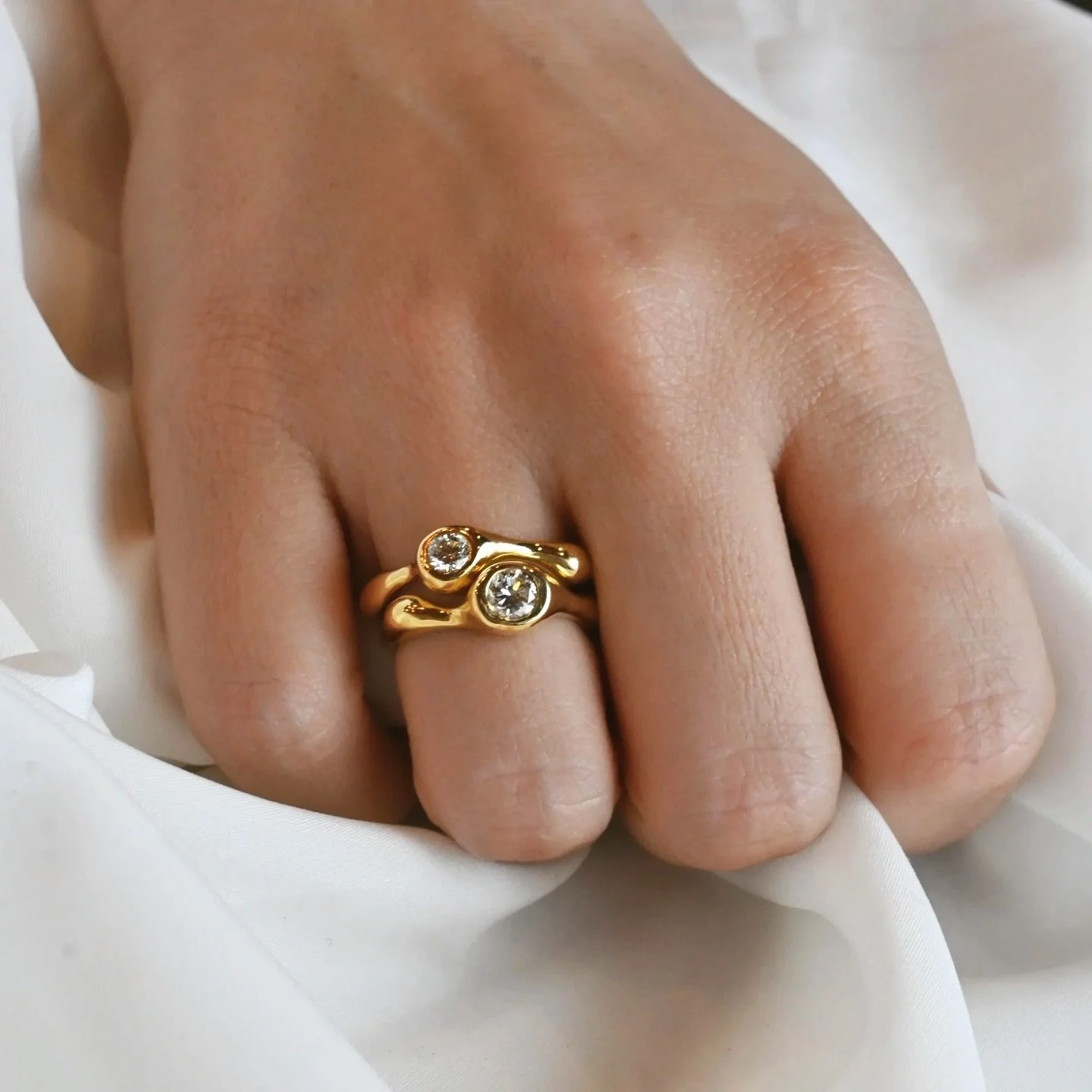 Two rings, formed in conversation.

The ILA Twin Diamond Stack did not begin as a set. Each ring took shape on its own, guided by material and proportion, then came together into something fluid and continuous.

Crafted in 18K gold with 0.85 ctw of n