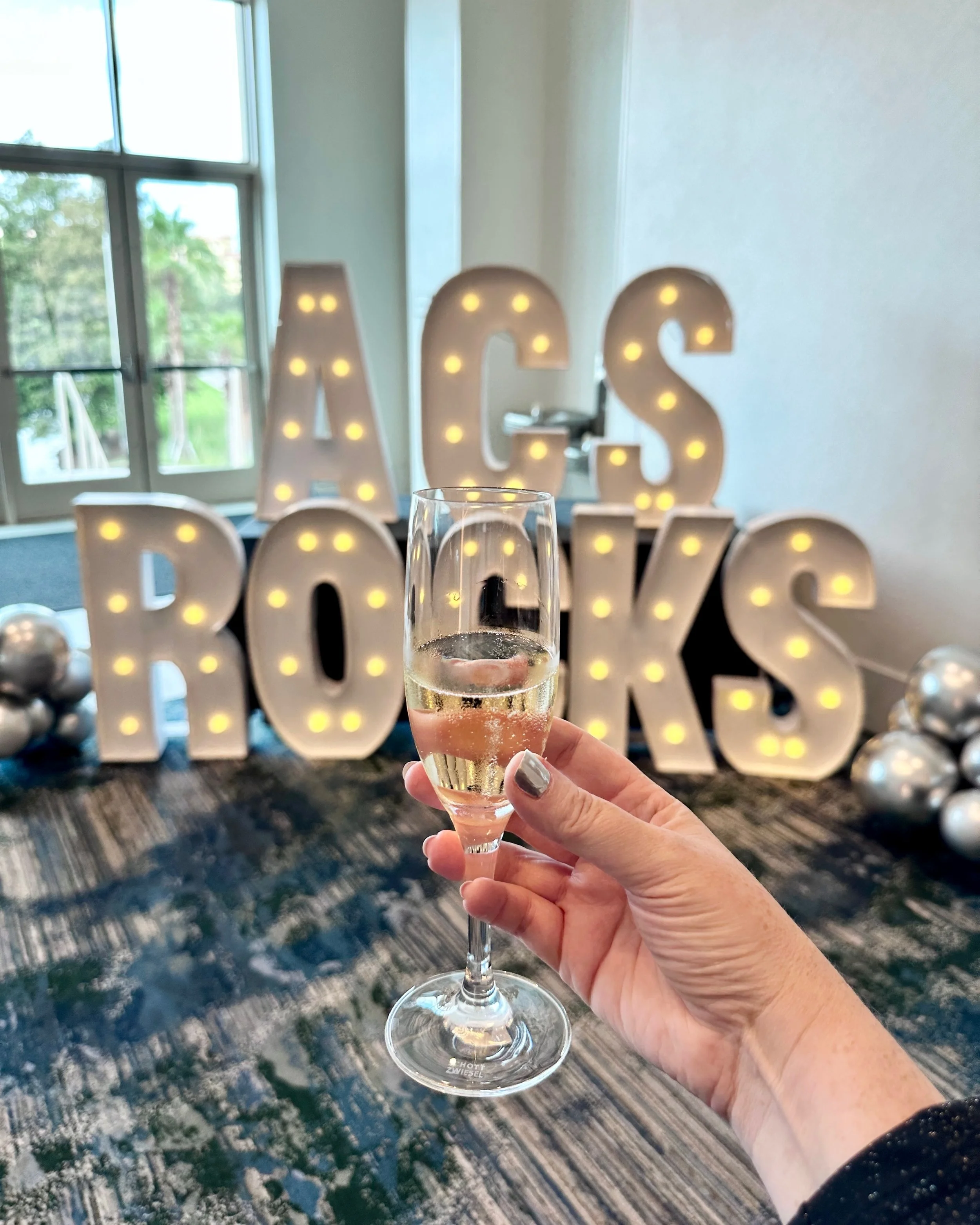 ACS Rocks in Giant Letters with Champagne in front