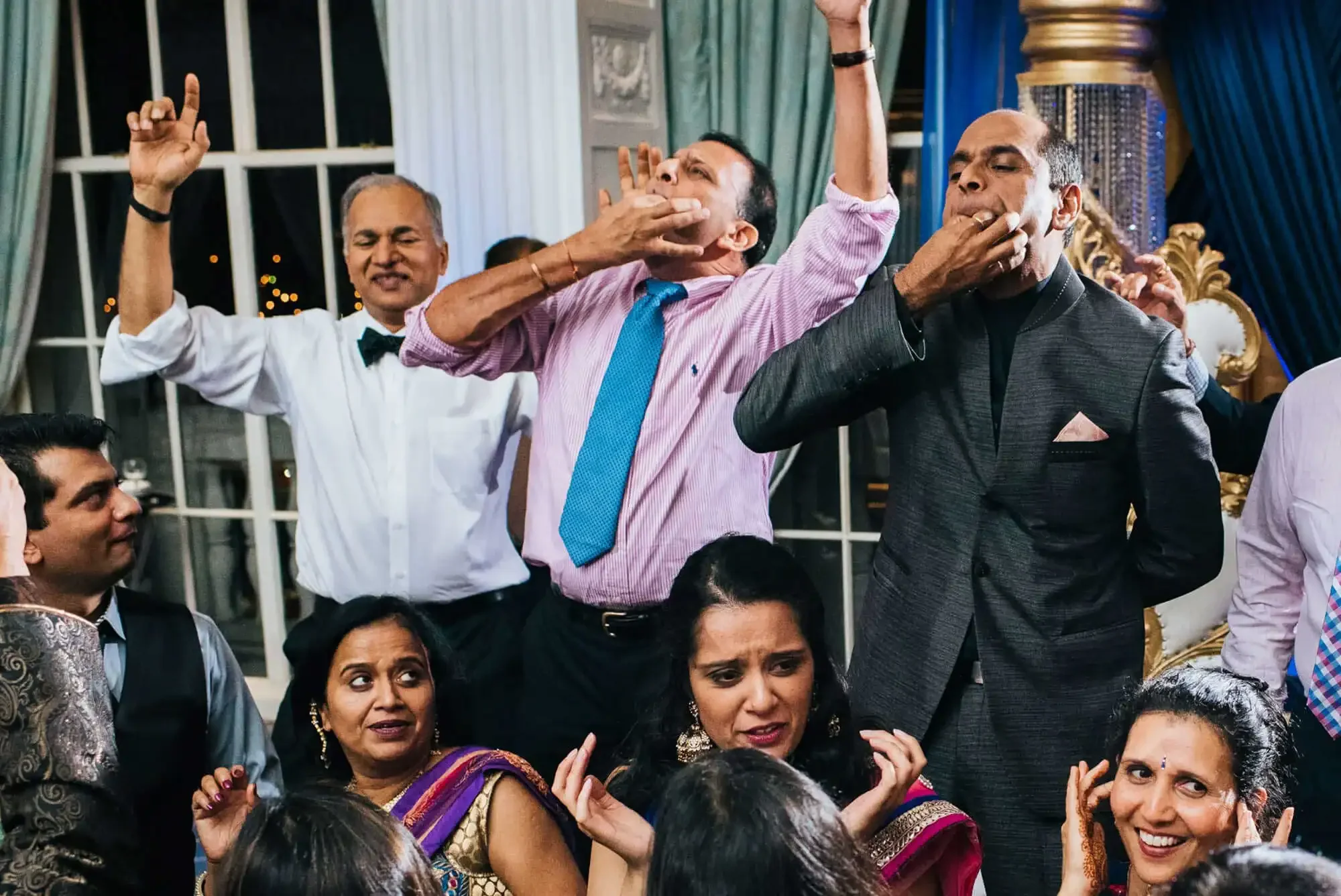 Wedding guests whistling on the dance floor at an Indian wedding reception at the Marriott Grand in downtown St. Louis, MO