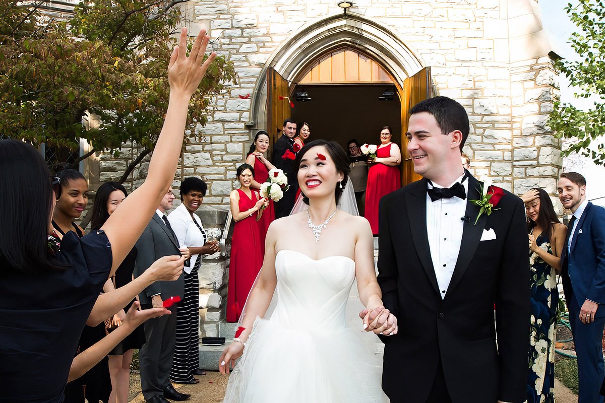 st-louis-church-wedding-exit-asian-bride-groom-after-ceremony-red-flowers.jpg