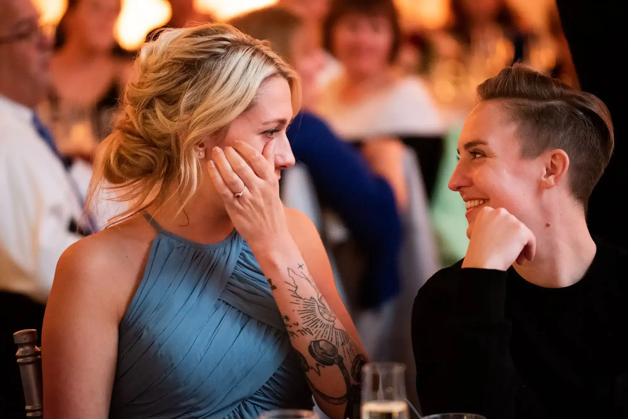 Wedding guests having an emotional moment looking at each other during a wedding speech at a St. Louis wedding reception. 