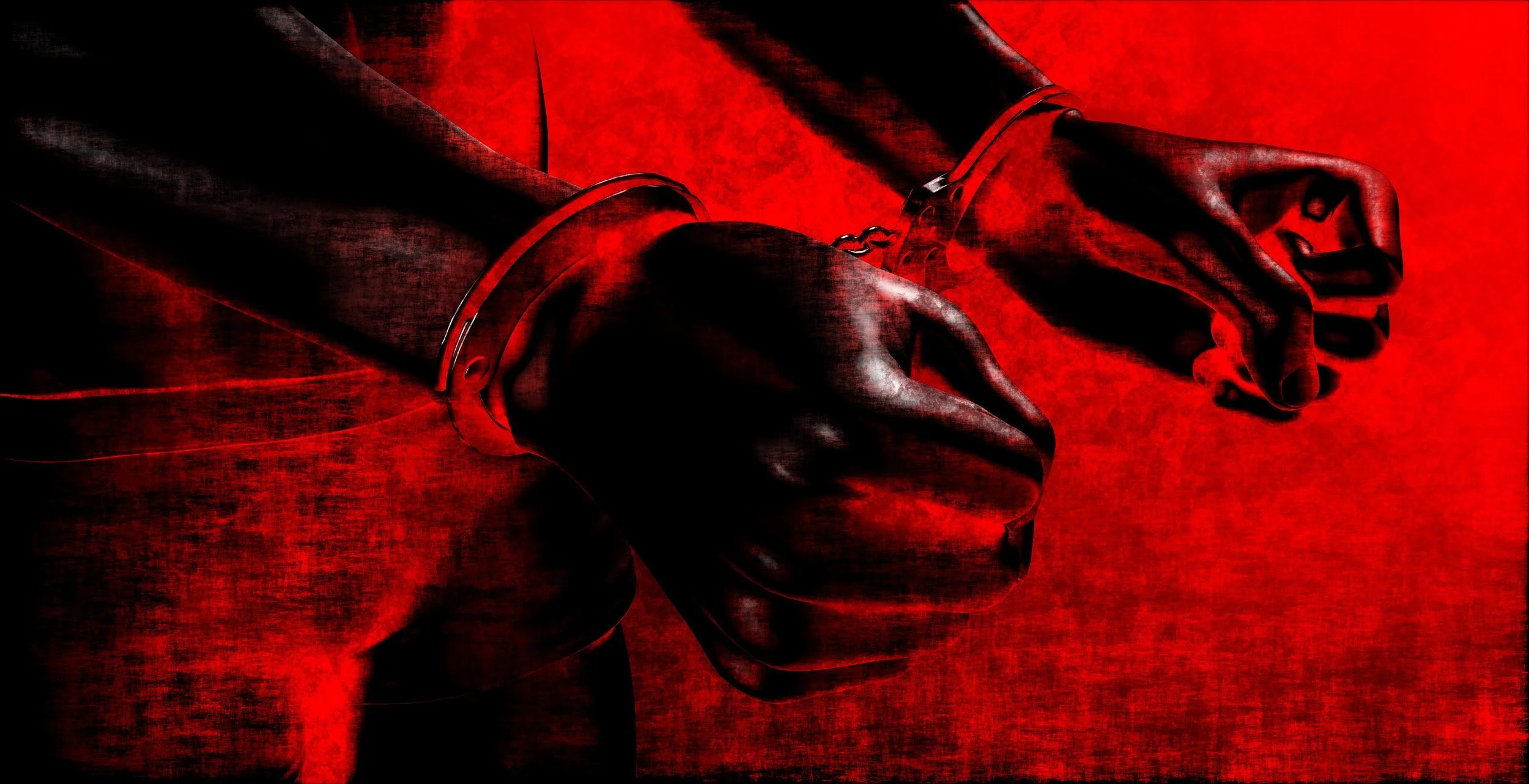 Close-up of hands in handcuffs against a red background, suggesting arrest or detention.