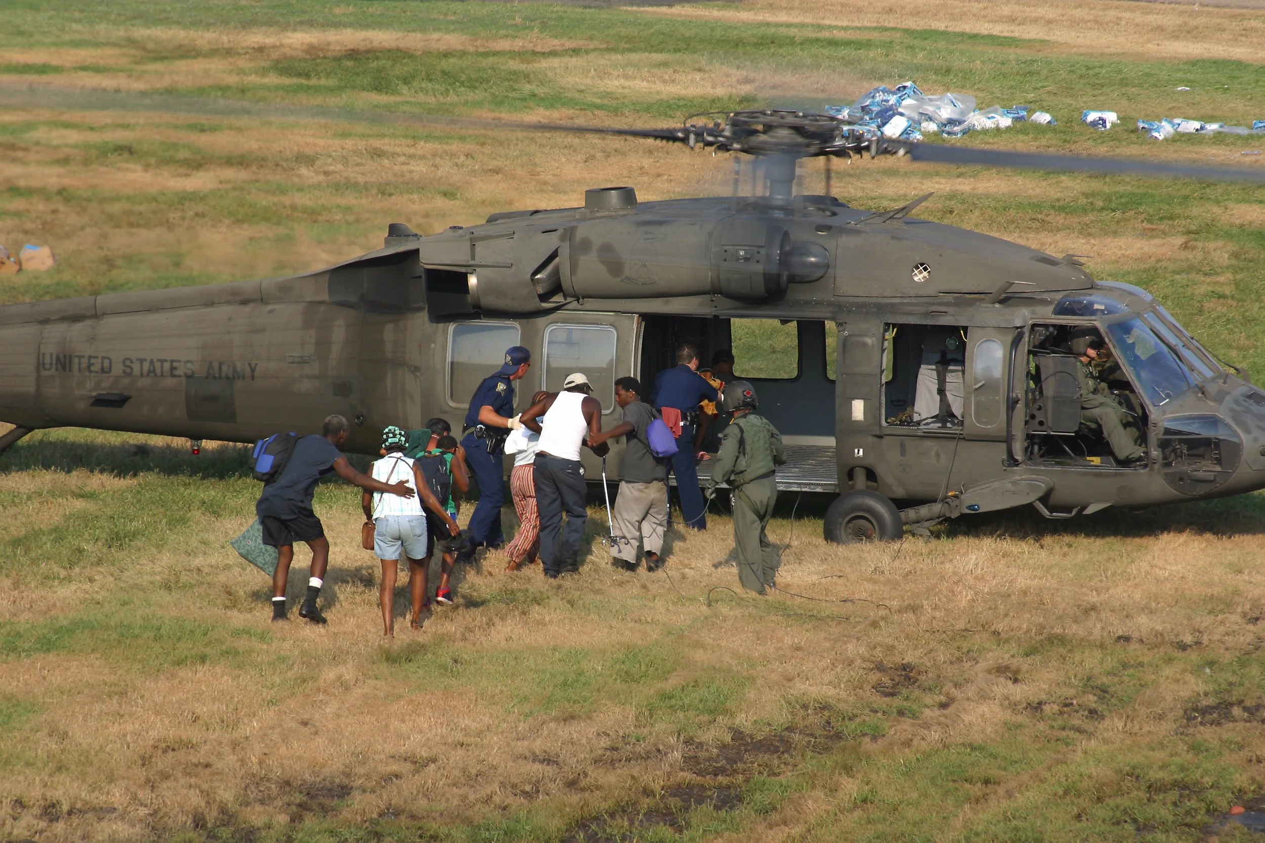 Hurricane Katrina evacuees boarding a U.S. Army helicopter, as featured on Steven Gray's Wall Street Journal portfolio.