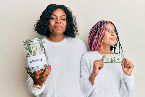 A mother and daughter saving money.