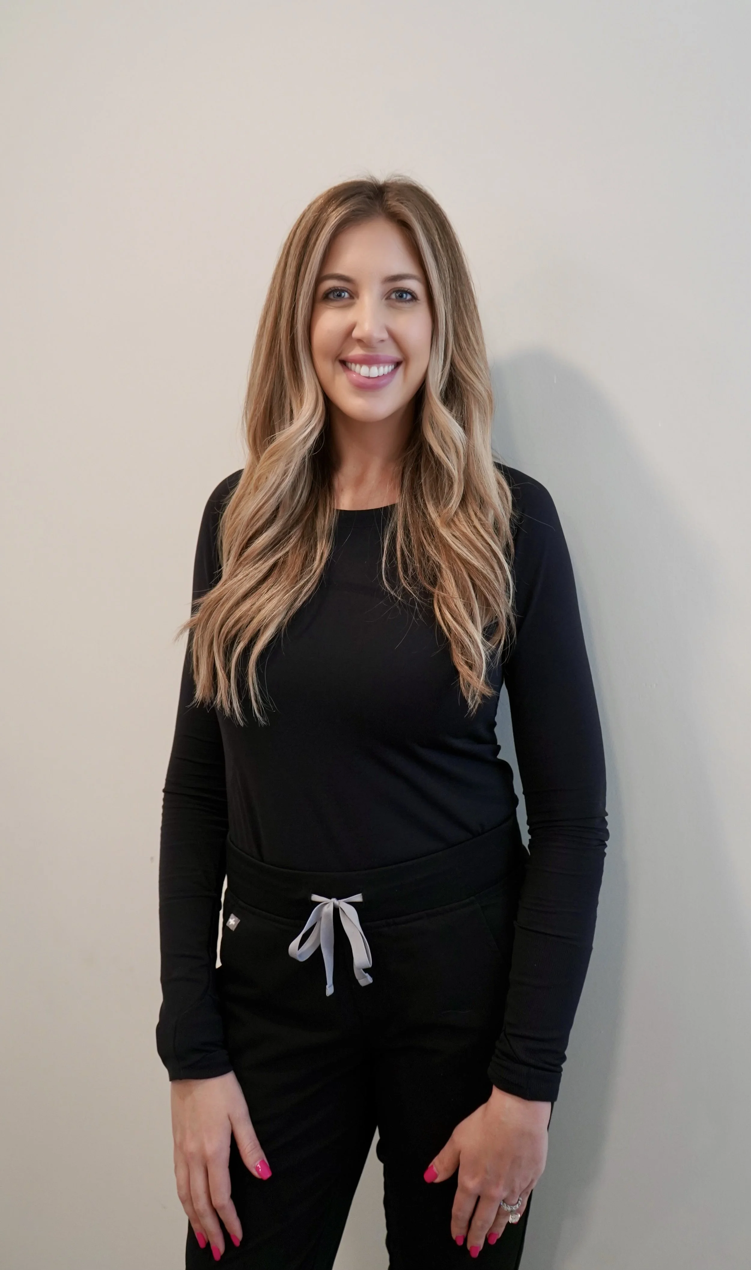 Üesthetics team members Jamie Gleason, Meghan Scarzo, and Amber Cinfio, Indianapolis medspa professionals, smiling and welcoming guests, featured on the About Us page.