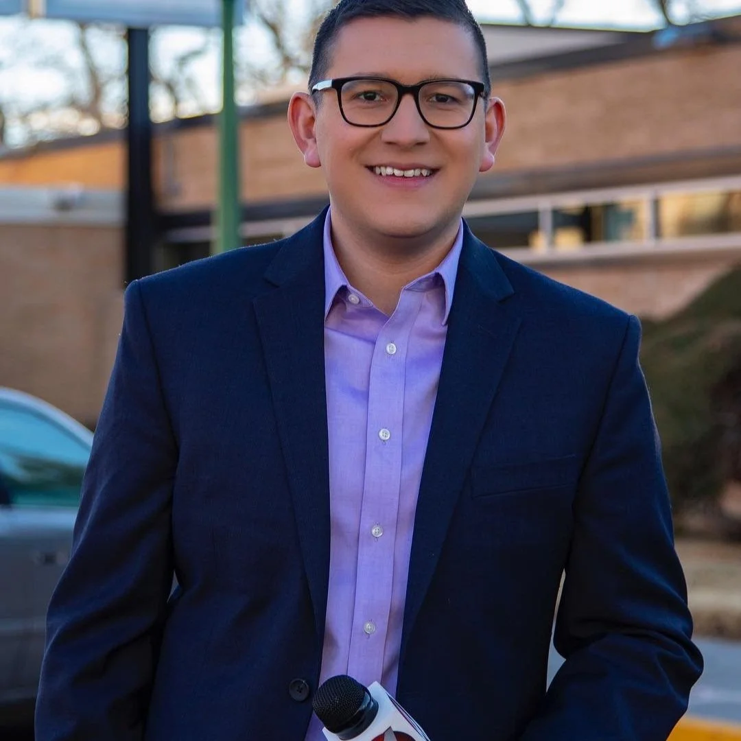 Hawker Vanguard, news correspondent, holding KOB 4 microphone