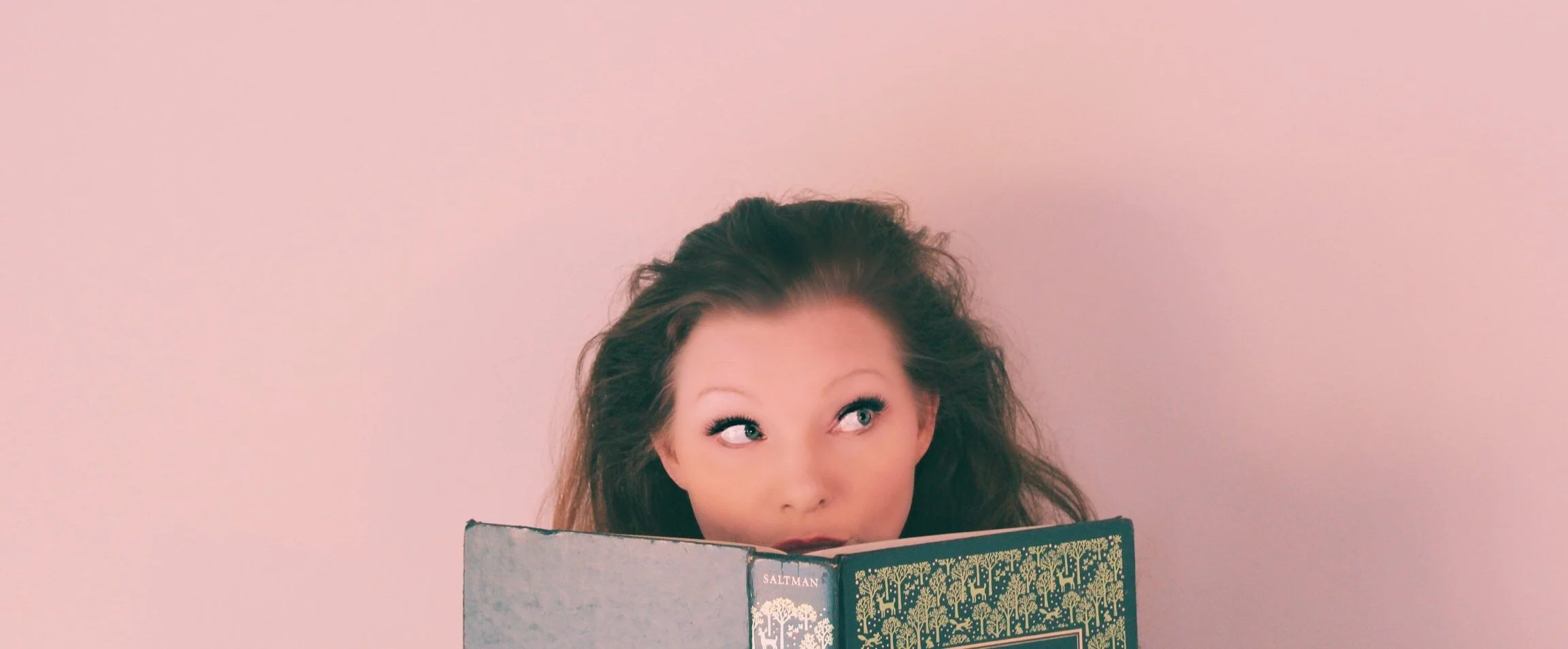 Blissom looking to the right with book in face