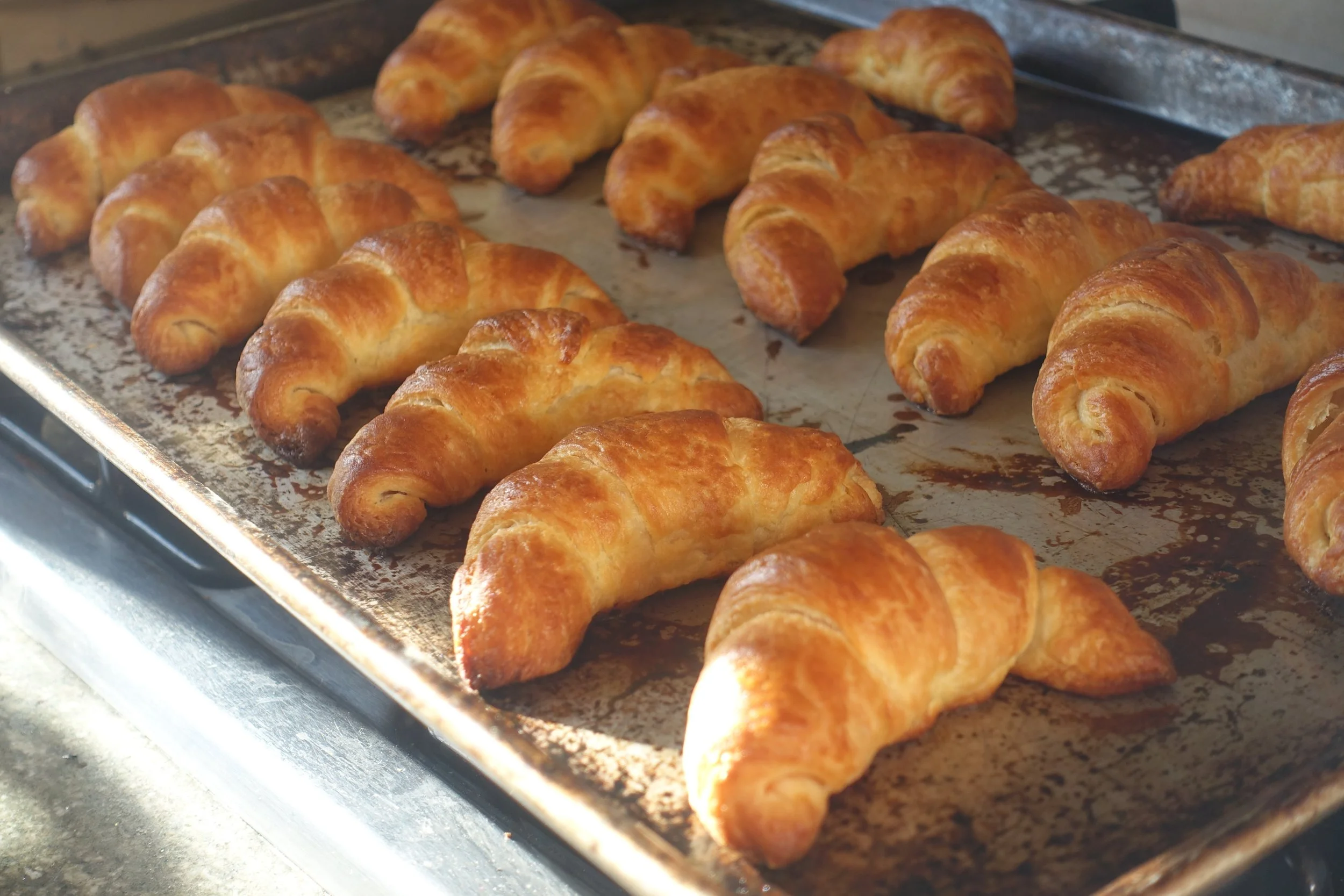 Baked croissants on a baking sheet