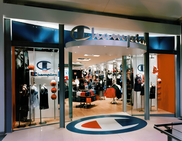 Storefront of champion sports apparel store with basketball-themed decor and merchandise display inside.