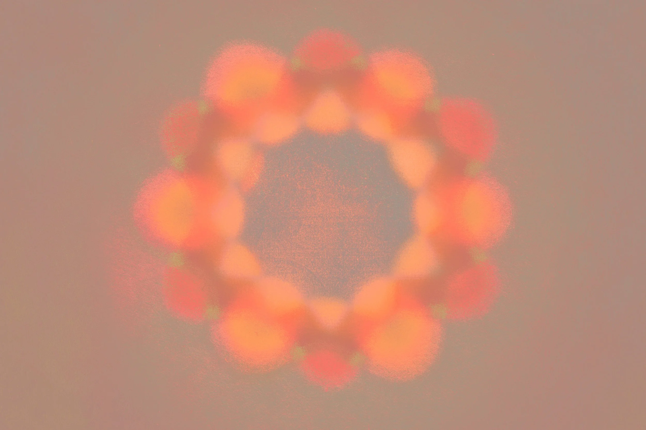 Abstract image featuring a circular pattern of blurred reddish-orange lights against a muted background.