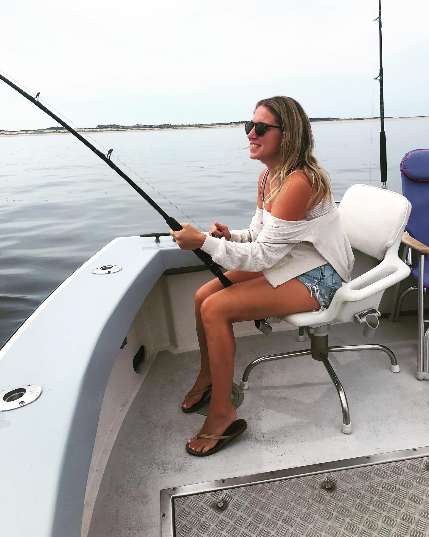 My daughter Shelby reeling in a nice striper