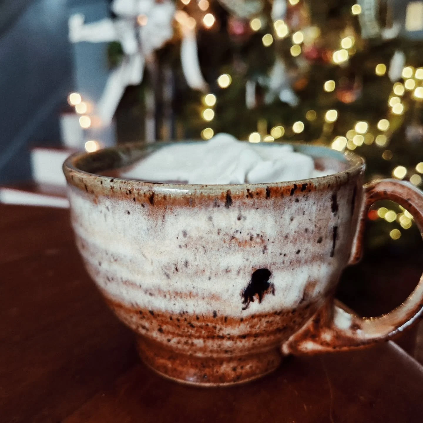 A two mug (so far) day.
The second one was my morning coffee today. It pairs well with Christmas and snowy mornings and steamy beverages. I love the altered shape and flared profile and all the slip trailed details and, of course,  the green.
The fir