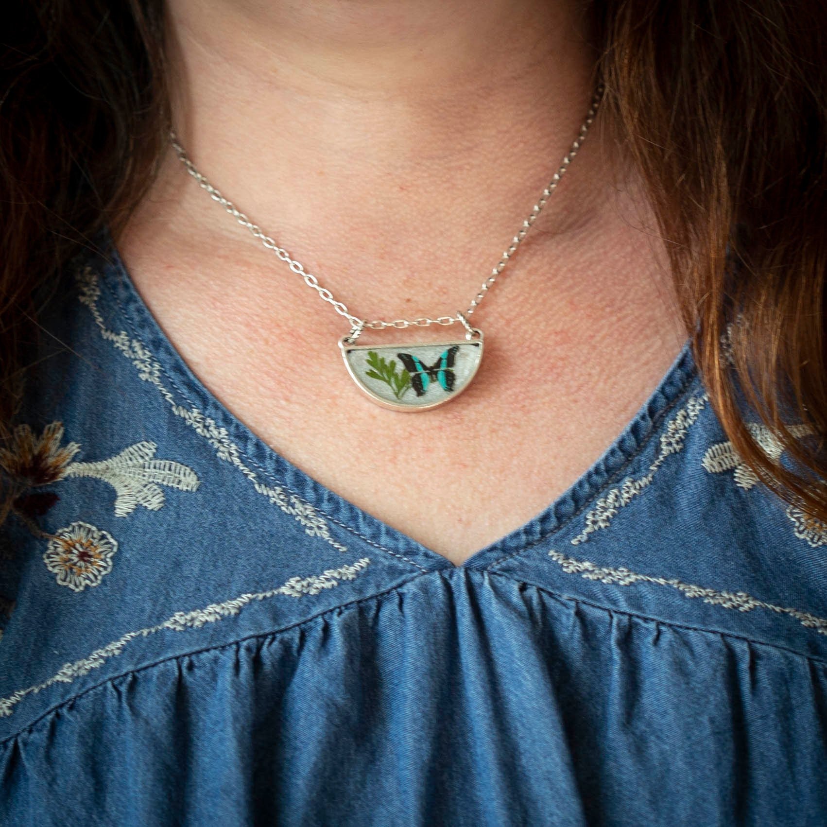 Antique silver necklace with half-circle pendant of real pressed leaf, bluebottle butterfly design, & smoky quartz gemstone in resin on a fine silver cable chain - appreciate the beauty of nature.