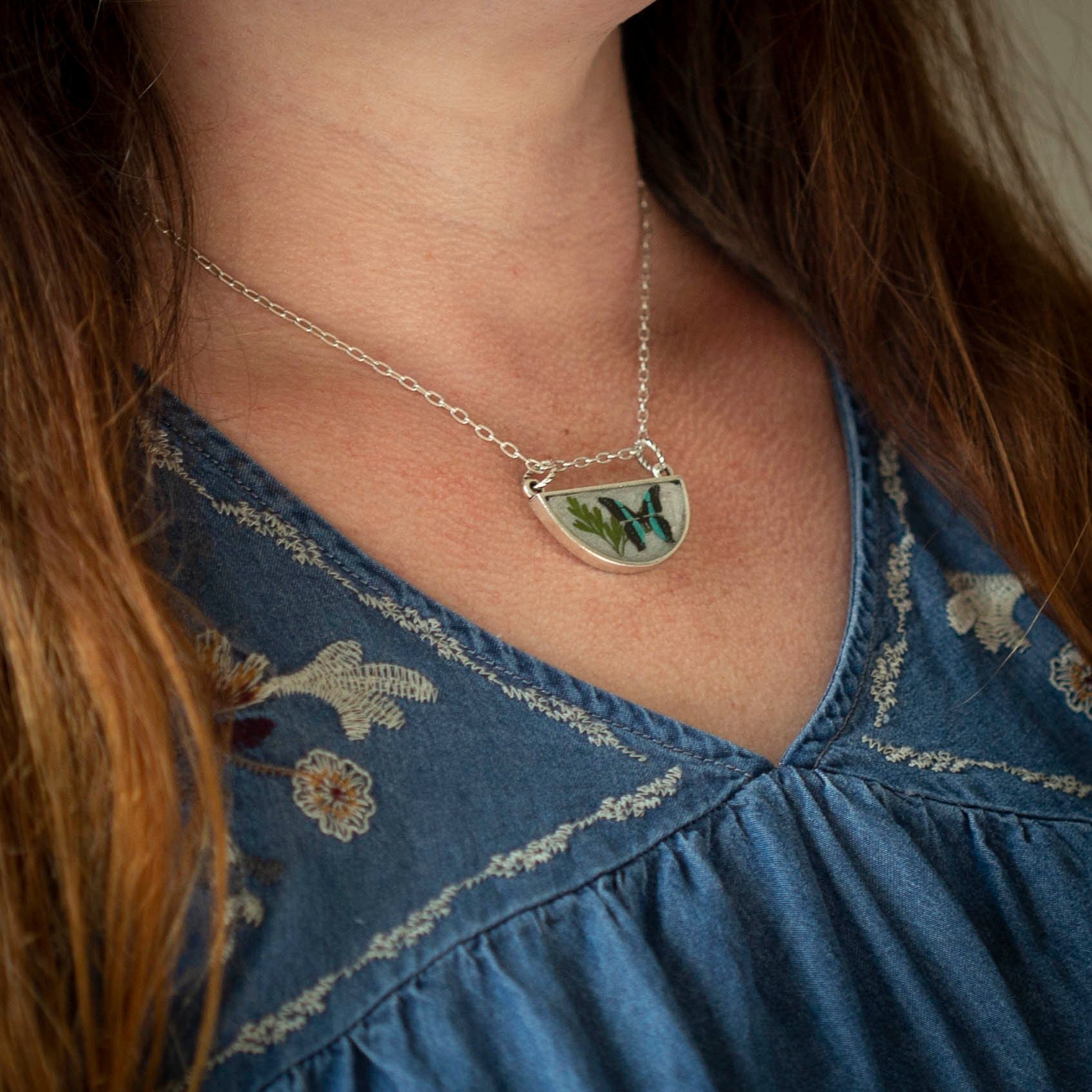 Antique silver necklace with half-circle pendant of real pressed leaf, bluebottle butterfly design, & smoky quartz gemstone in resin on a fine silver cable chain - appreciate the beauty of nature.