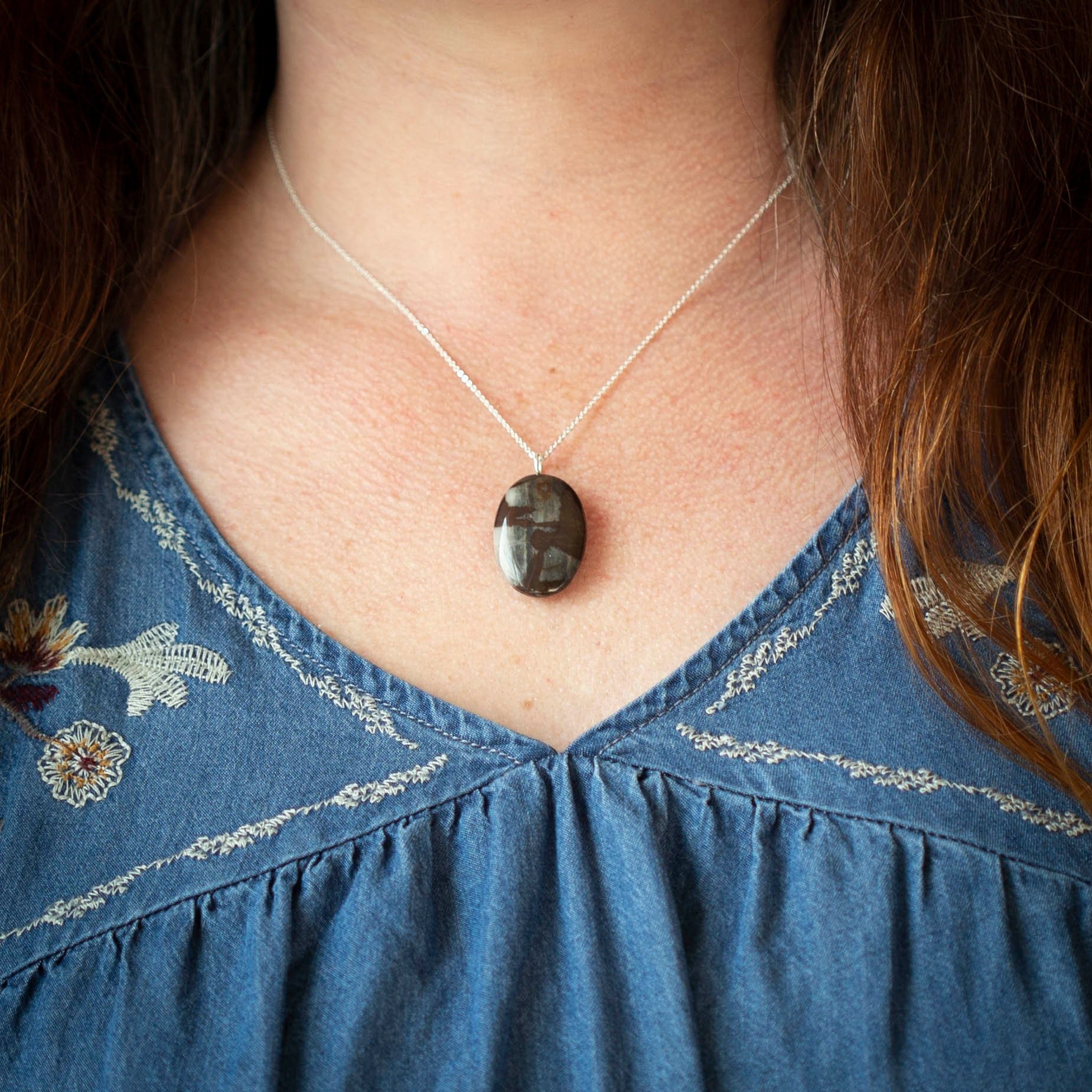 Australian outback jasper stone that has earthy brown and beige colors with black clay on the back silver gemstone necklace.