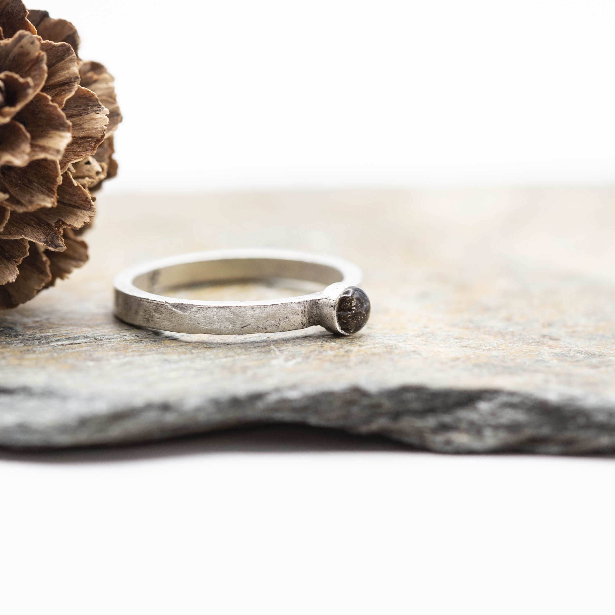 A fine silver plated pewter stacking ring with a bold circle setting of Canyon Diablo Meteorite in resin, bringing the stars closer to you.
