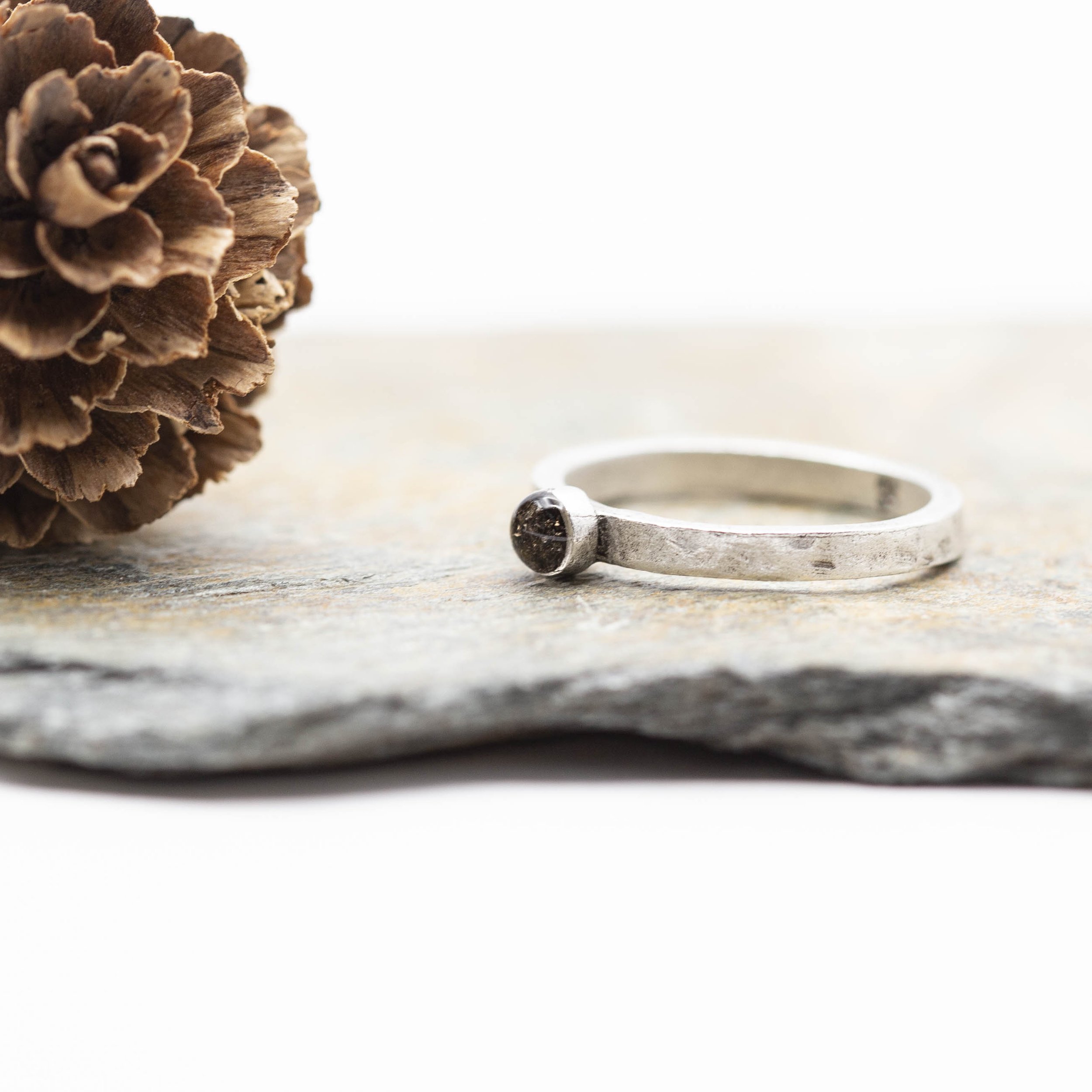 A fine silver plated pewter stacking ring with a bold circle setting of Canyon Diablo Meteorite in resin, bringing the stars closer to you.