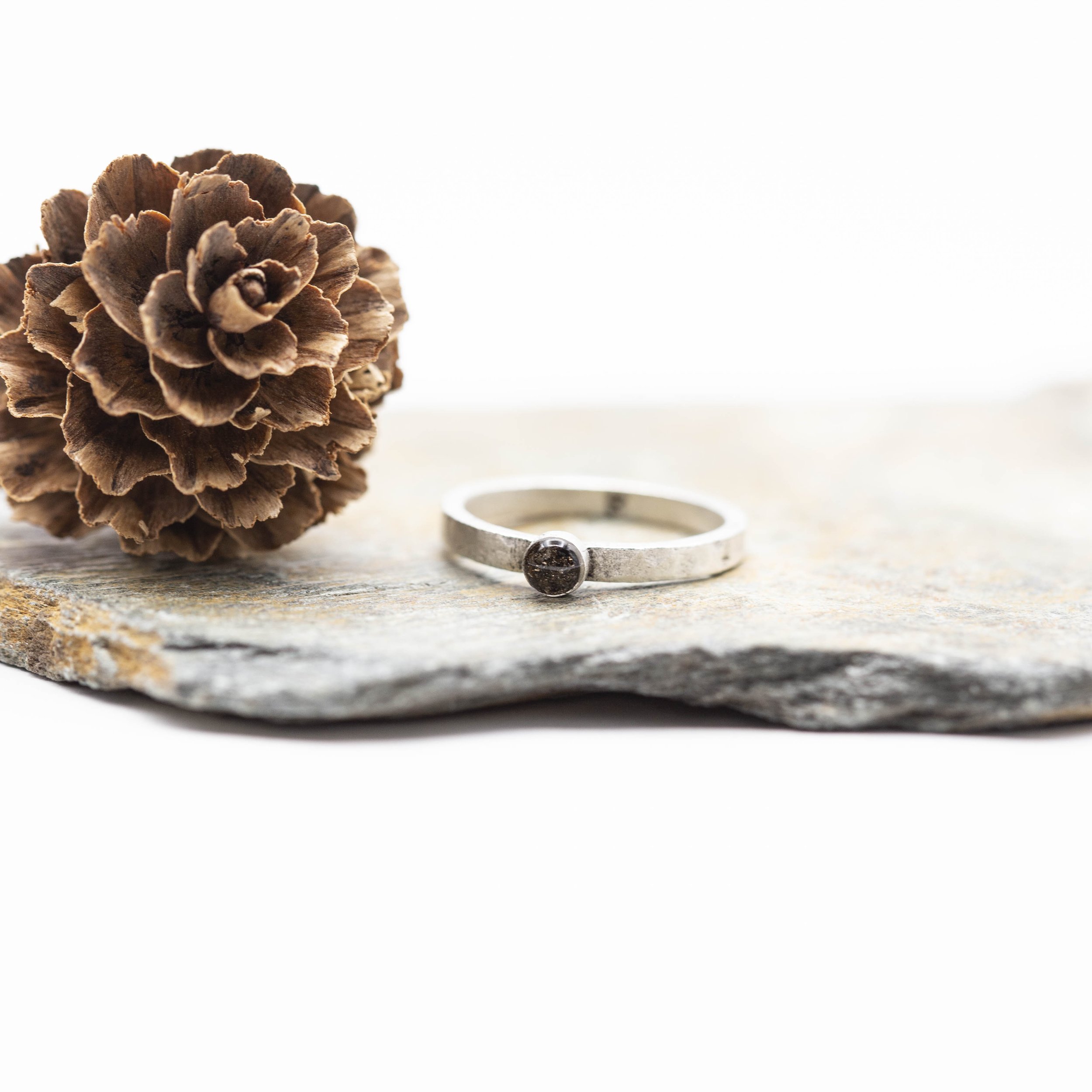 A fine silver plated pewter stacking ring with a bold circle setting of Canyon Diablo Meteorite in resin, bringing the stars closer to you.