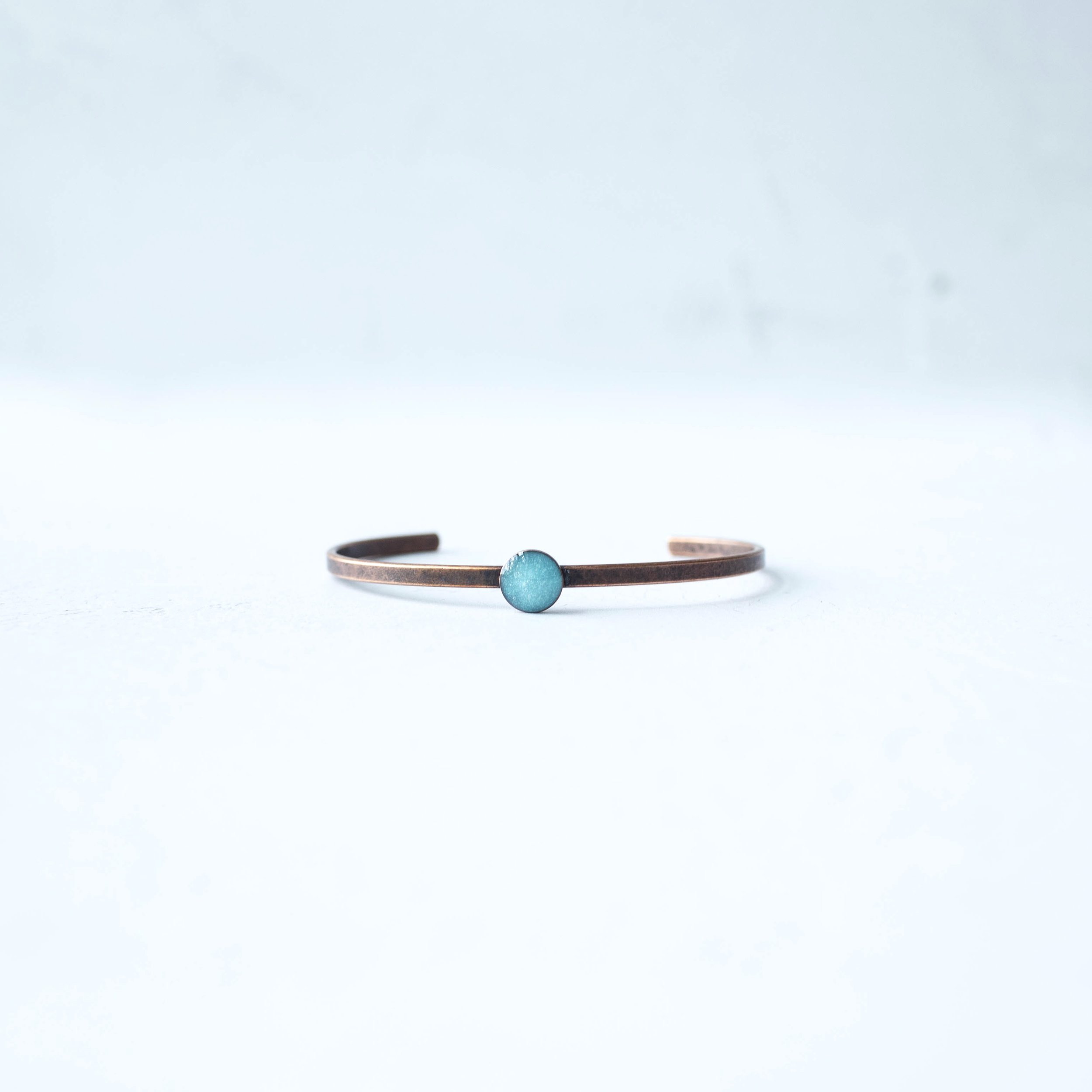 Explore the symbolism of Southwest Turquoise with our Copper Cuff Bracelet featuring crushed turquoise in resin. Perfect for adding a touch of Southwest charm to any outfit.
