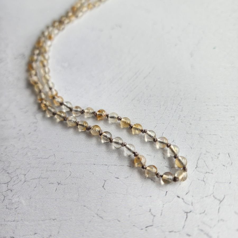 hand knotted citrine bead necklace with 4mm beads on pure silk cord finished with a silver lobster claw clasp handmade lightweight and elegant jewelry