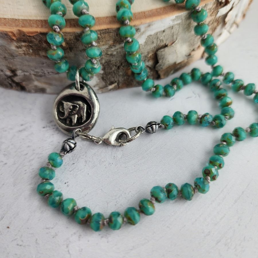 hand knotted green czech glass bead necklace with pewter elephant charm and happy memories engraved on the back handmade jewelry with lobster clasp