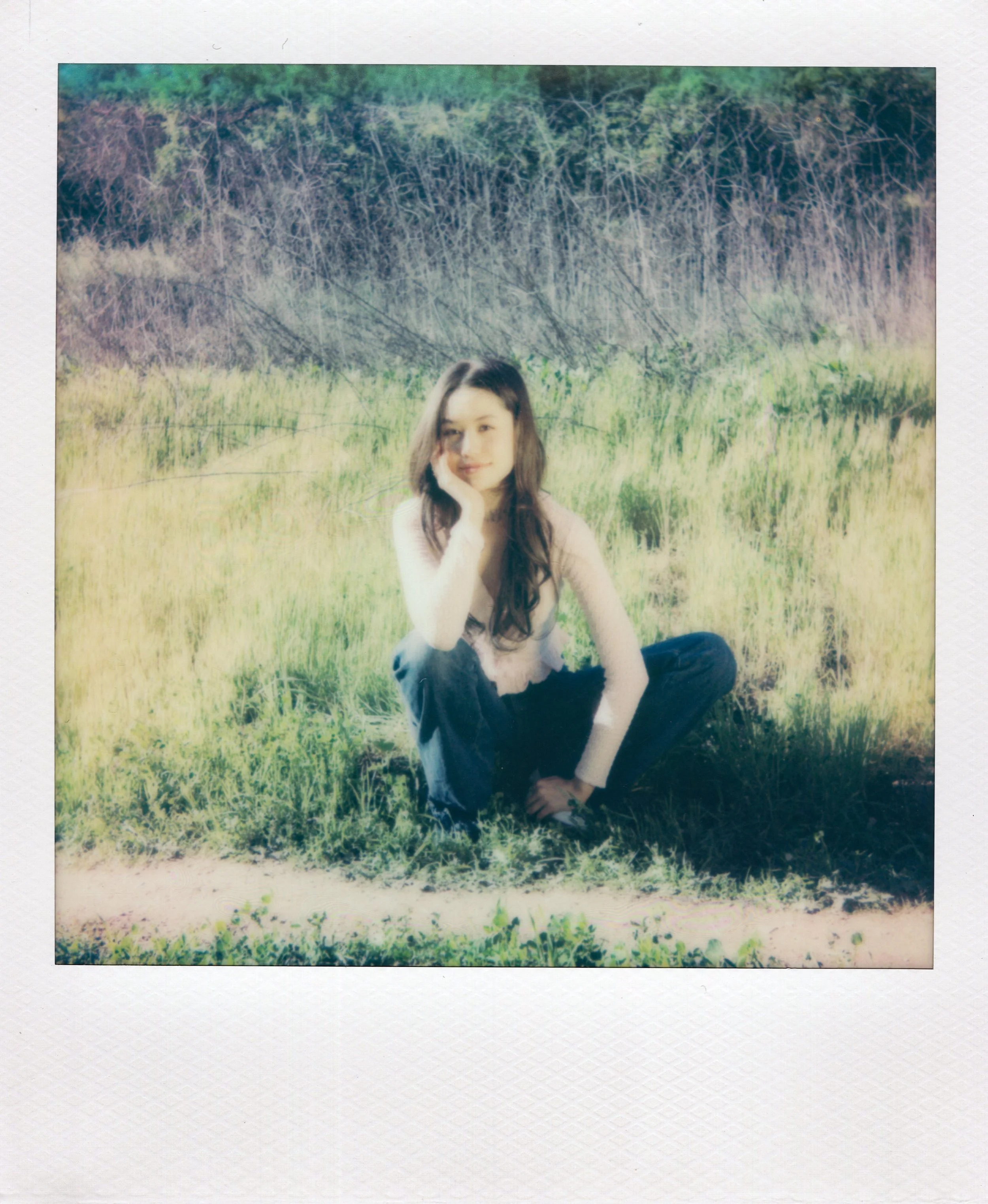Polaroid of girl sitting in nature