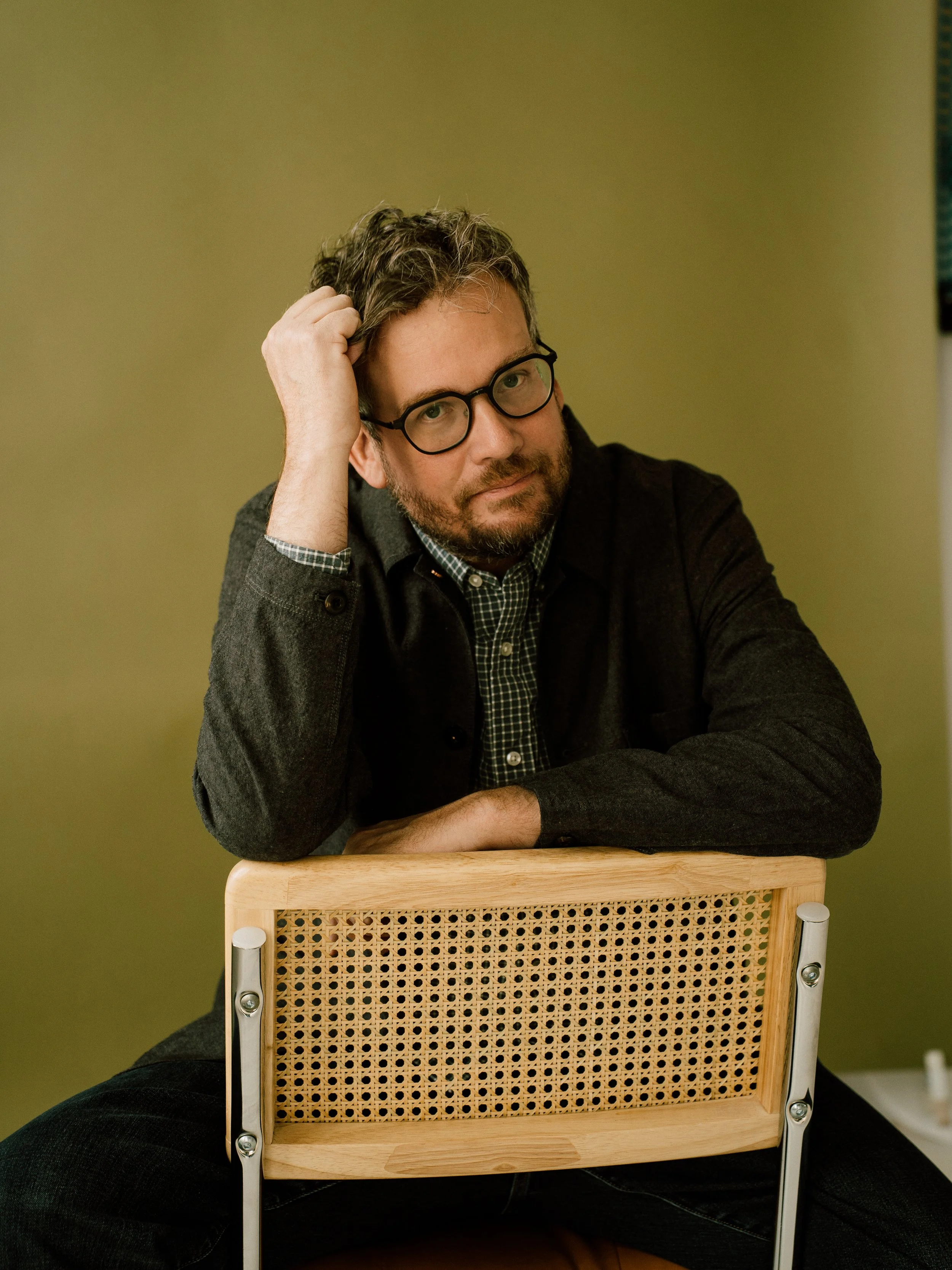 Man (John Green) in front of green backdrop
