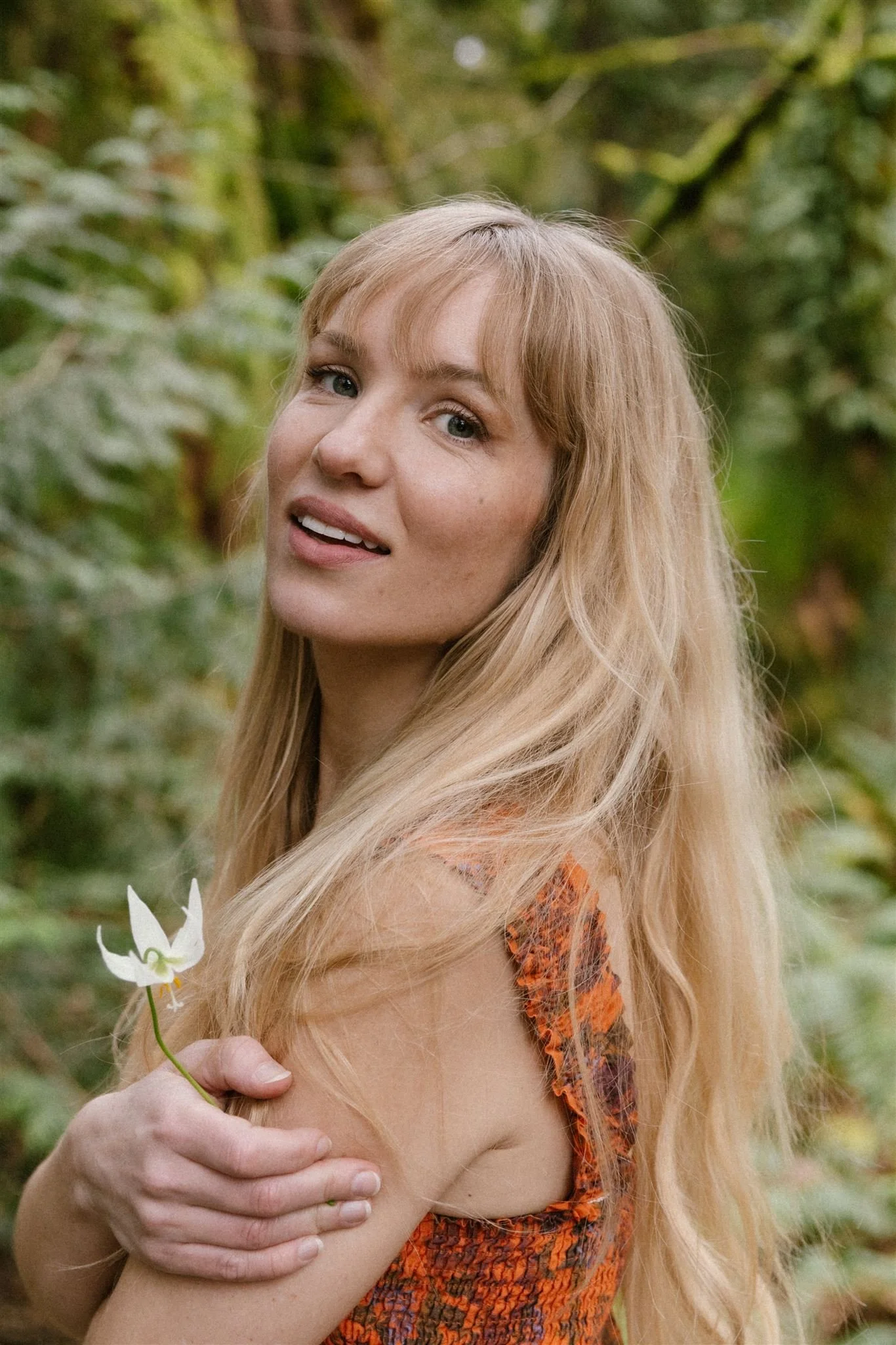 Woman looks over shoulder in nature