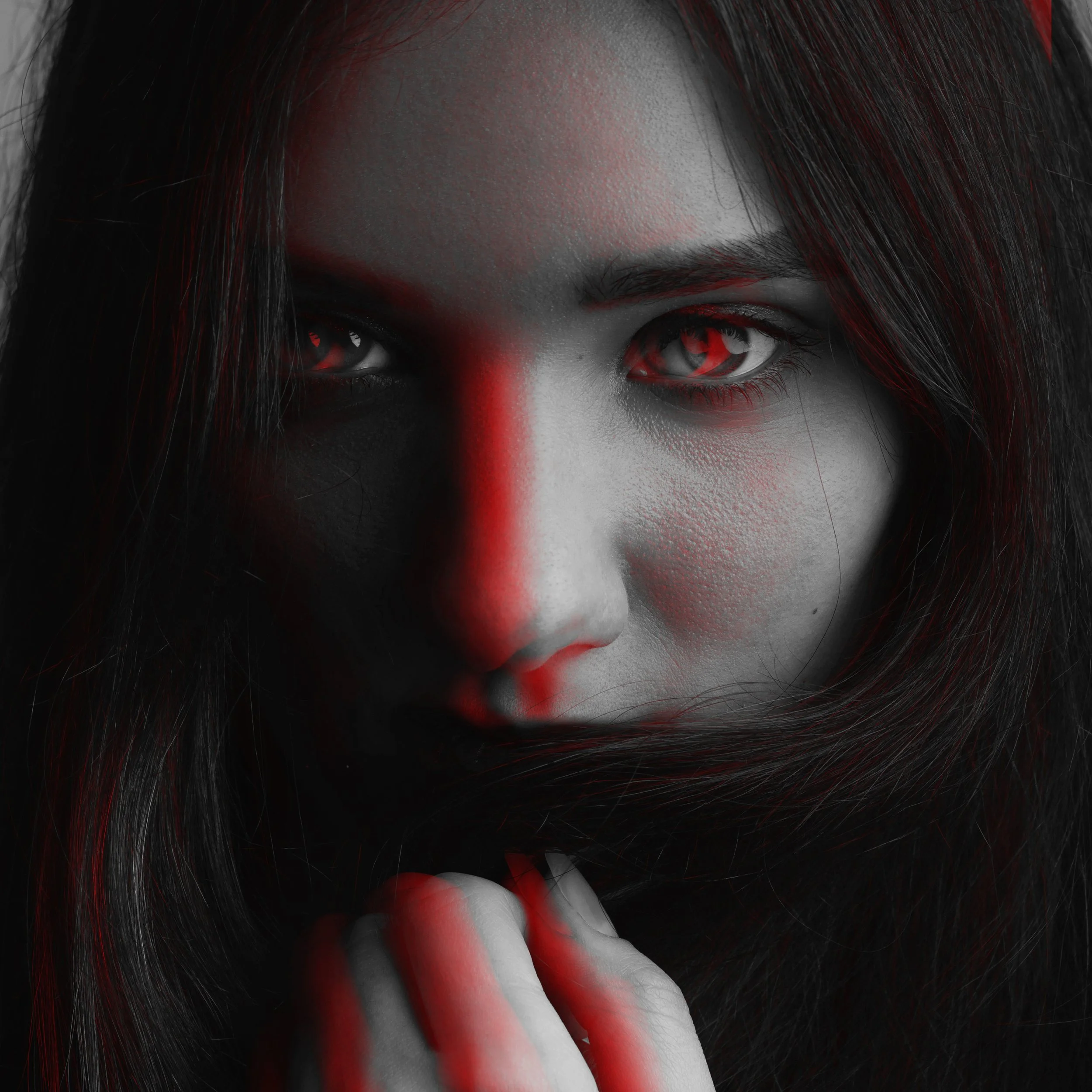 Stylized vampire portrait with dramatic red lighting used for The Traveling Vampire Show atmosphere.