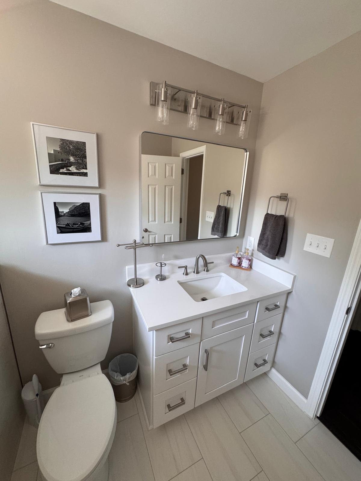 White shaker bathroom vanity with quartz countertop and brushed nickel fixtures in East Cobb, GA
