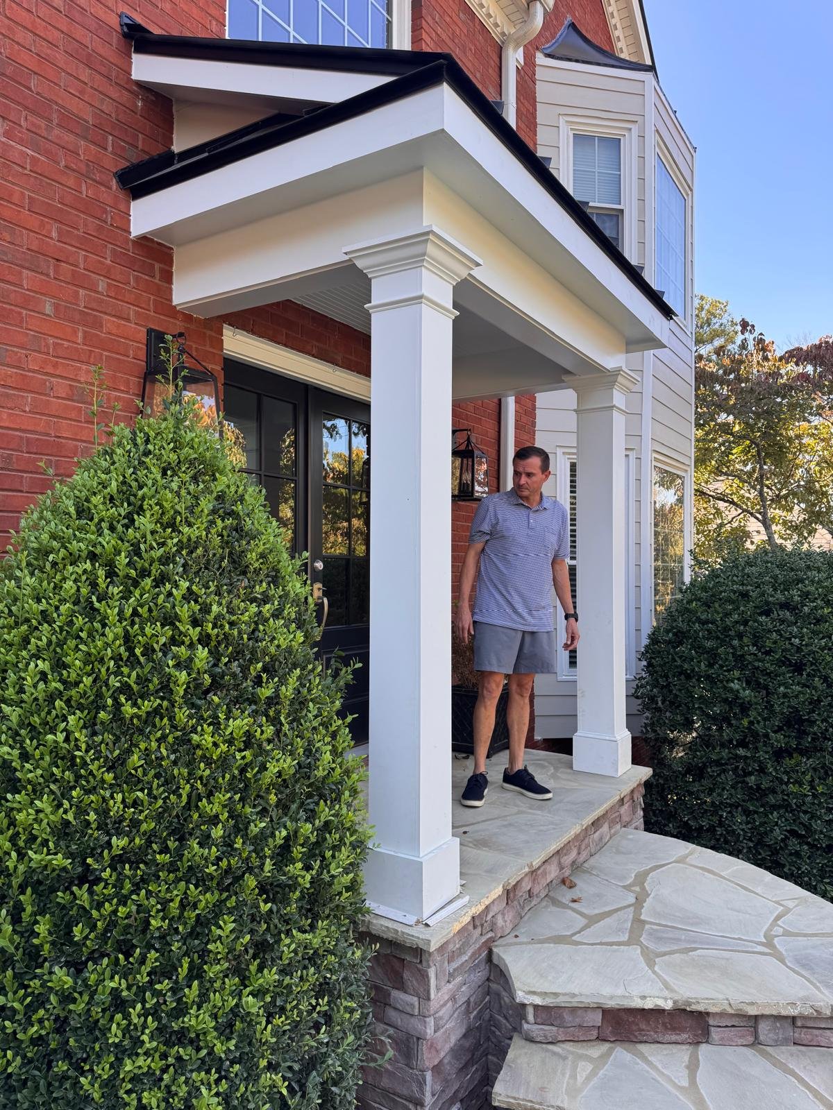 Front porch with white square columns and flagstone floor in East Cobb, GA