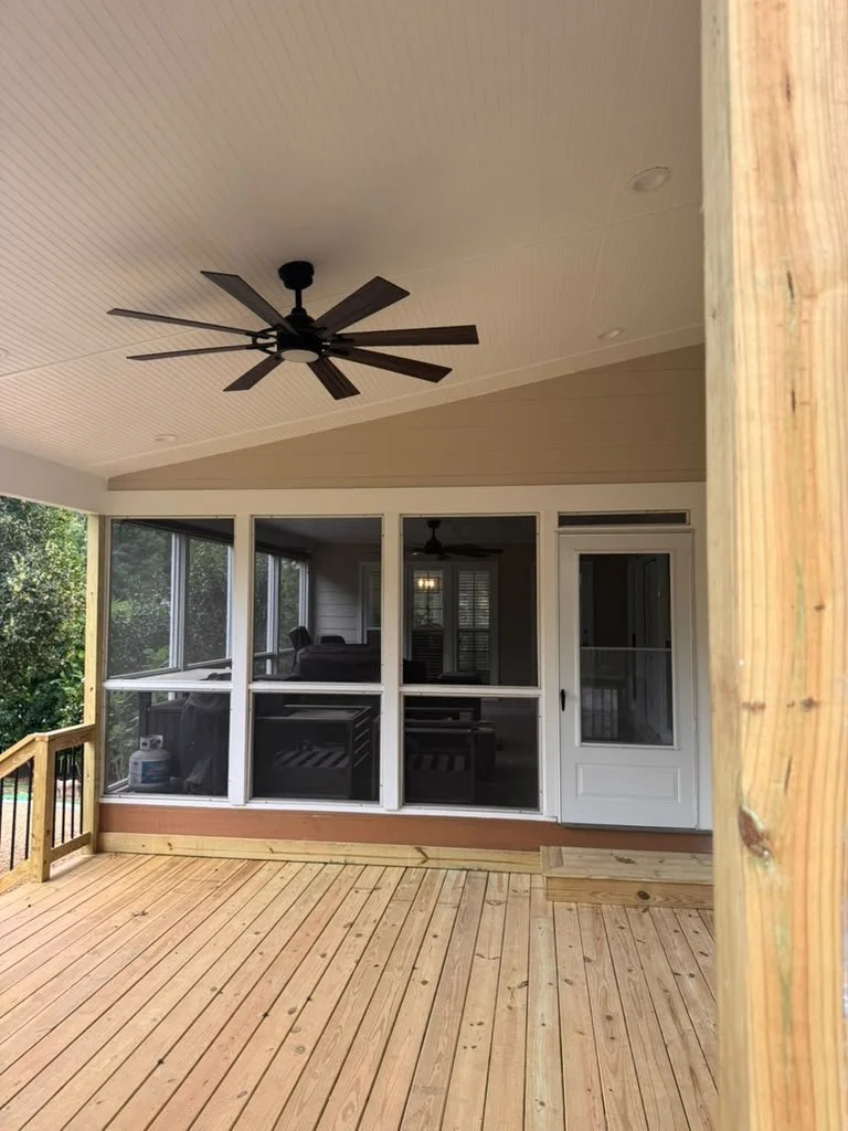 Covered deck and porch addition with ceiling fan, wood posts and new decking by A&J Remodeling