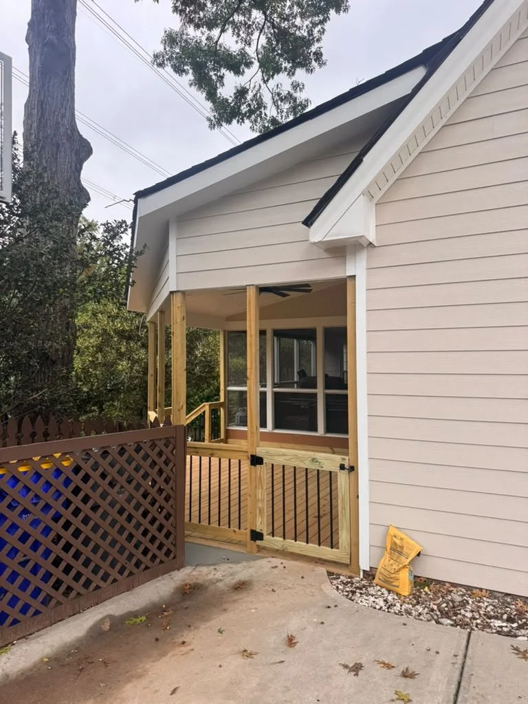Covered porch addition with gable roof, matching siding and a wood deck gate in East Cobb, GA