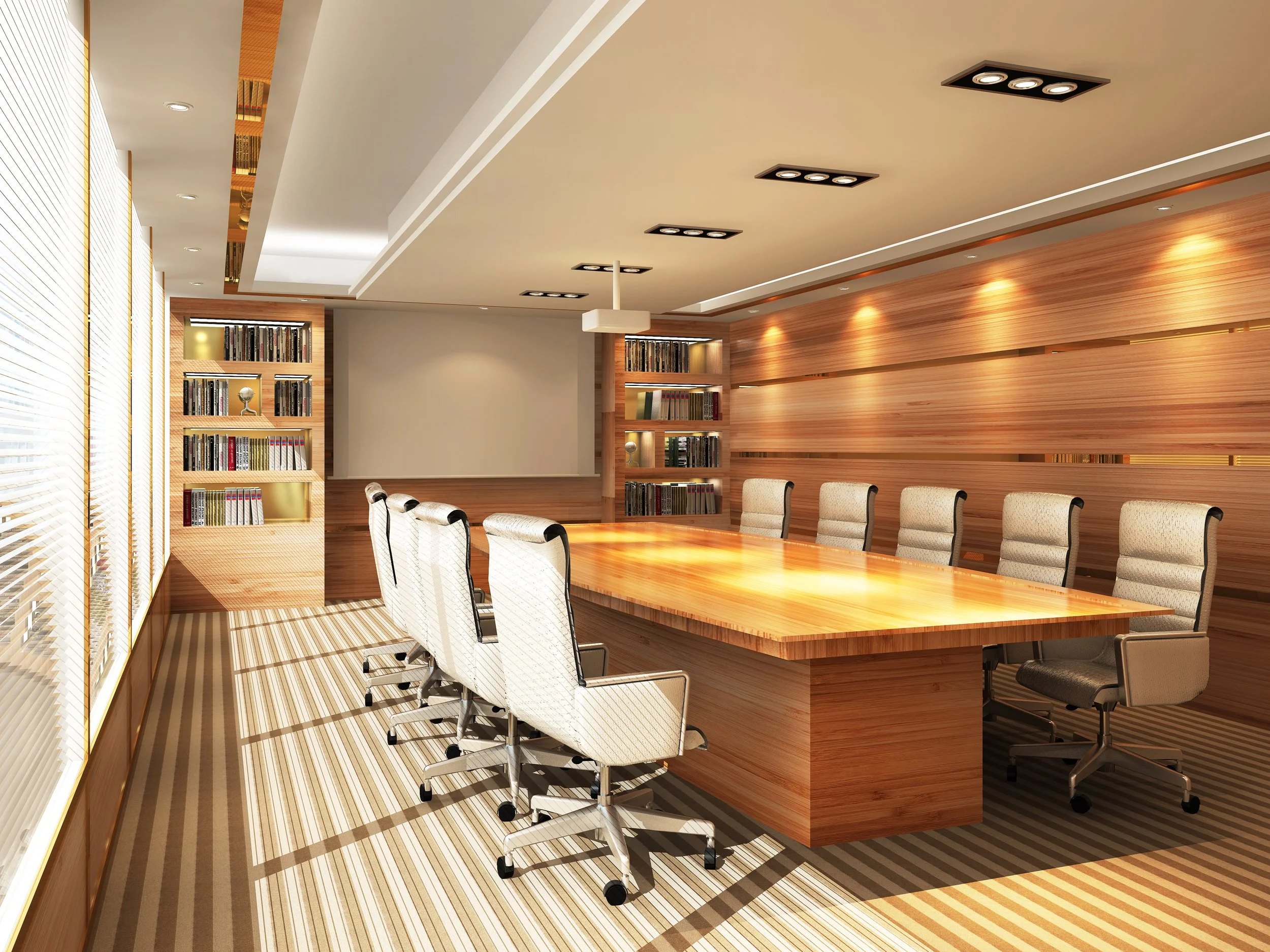 Long rectangular conference room table in an office setting with 8 executive style office chairs around it.