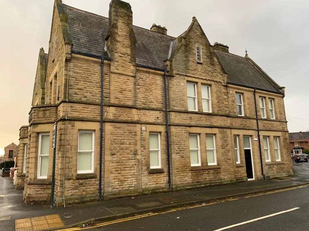 Convert the former 2 storey police station into six, one-bedroom apartments