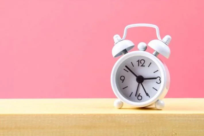Clock to symbolize the pressure to come out as trans at a certain time.