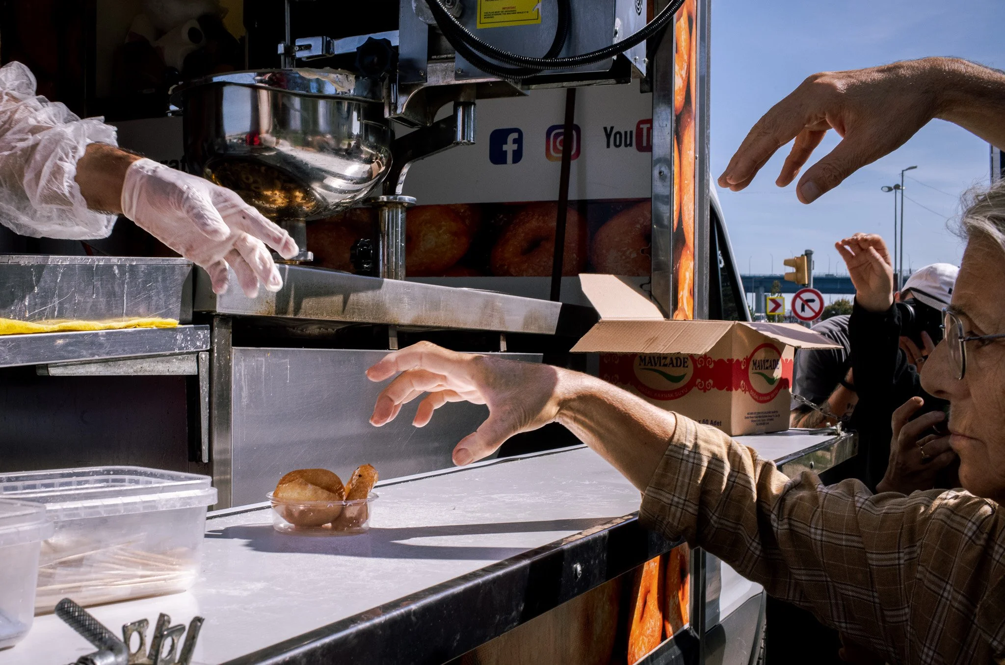 People reaching for the last donut in Istanbul. Award winning image from Dublin Street Photography Festival in 2025. 