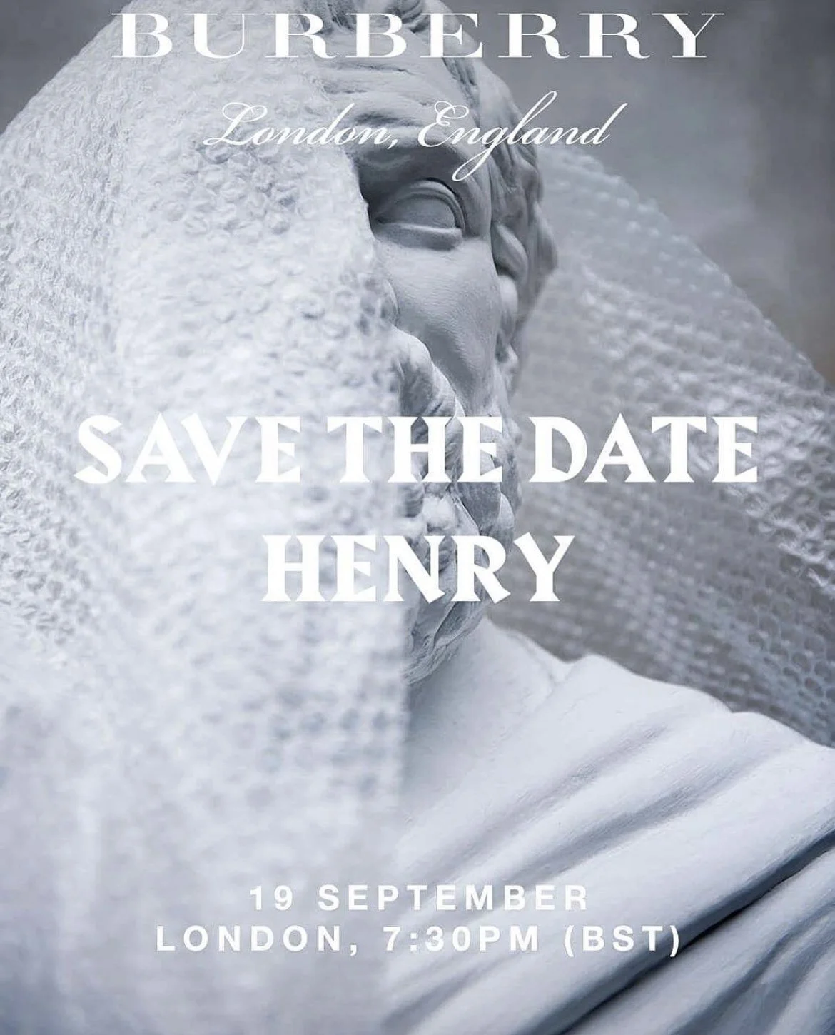 Save the date invitation for Burberry's runway show inspired by Henry Moore, featuring a close-up of a white marble statue of a person's face, partially covered with textured fabric.