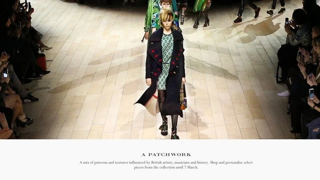 Model walking down runway in a patchwork coat and dress, audience watching and taking photos, fashion show setting.